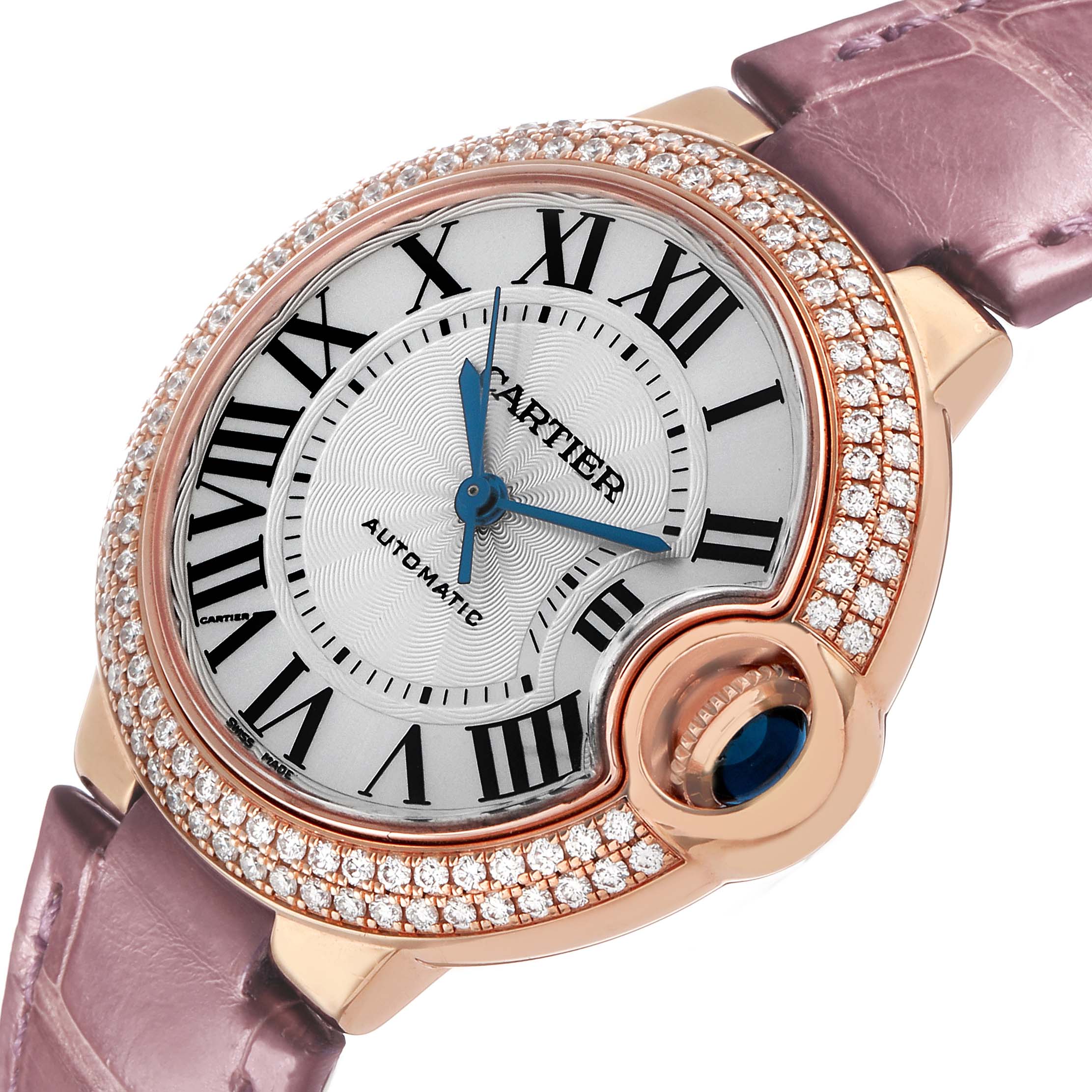 The Cartier Ballon Bleu WE902066 Women's Rose Gold Silver Dial watch is shown at an angle highlighting the face, crown, and diamond-studded bezel, with a pink strap visible.