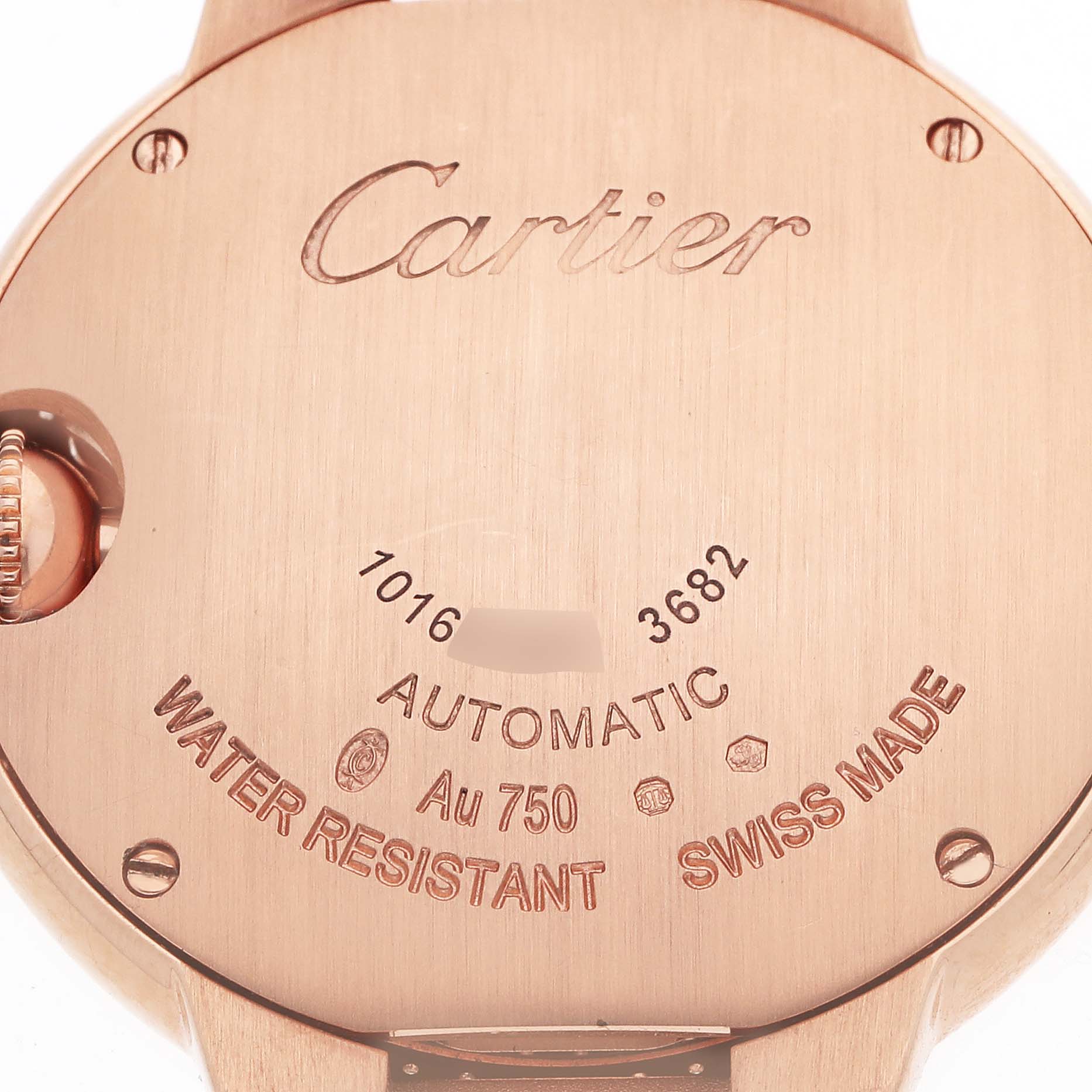 The image shows the back case of a Cartier Ballon Bleu WE902066 Women's Rose Gold Silver Dial watch, displaying engravings and the crown partially visible.