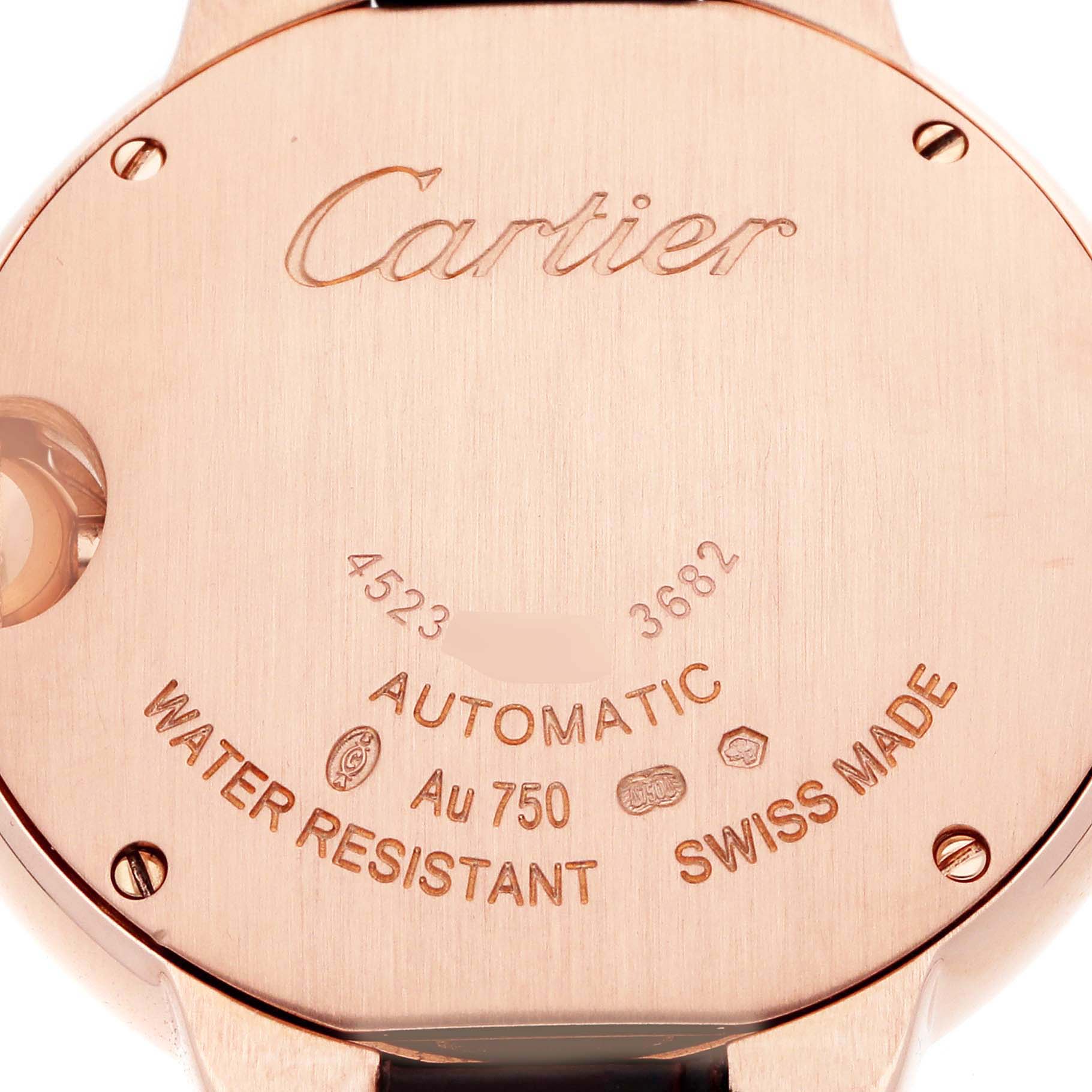 The image shows the back case of a Cartier Ballon Bleu W6920097 Women's Rose Gold Silver Dial watch, displaying engravings and screws.