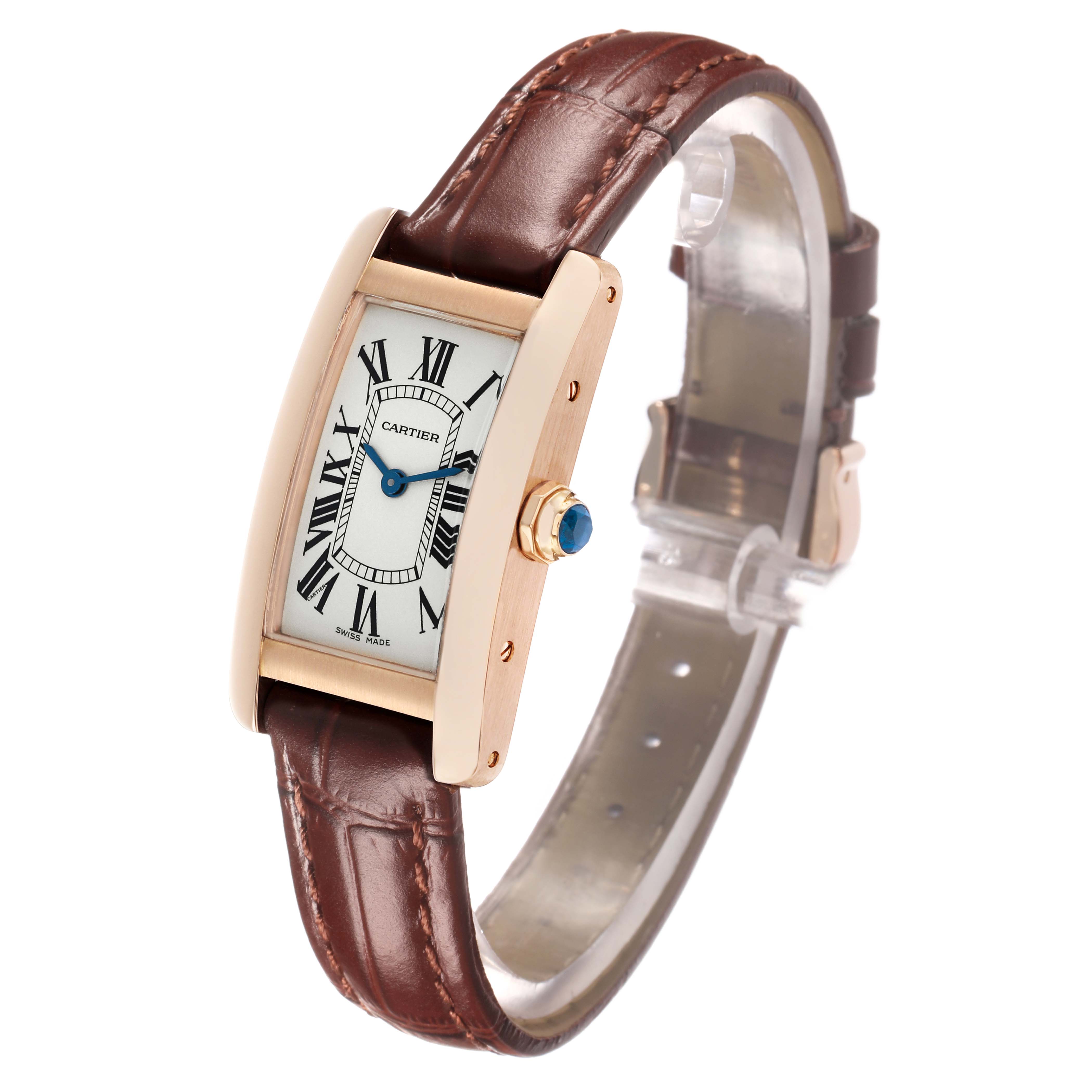 The Cartier Tank Américaine watch is shown at a three-quarter angle, highlighting its rectangular face, Roman numerals, and brown leather strap.