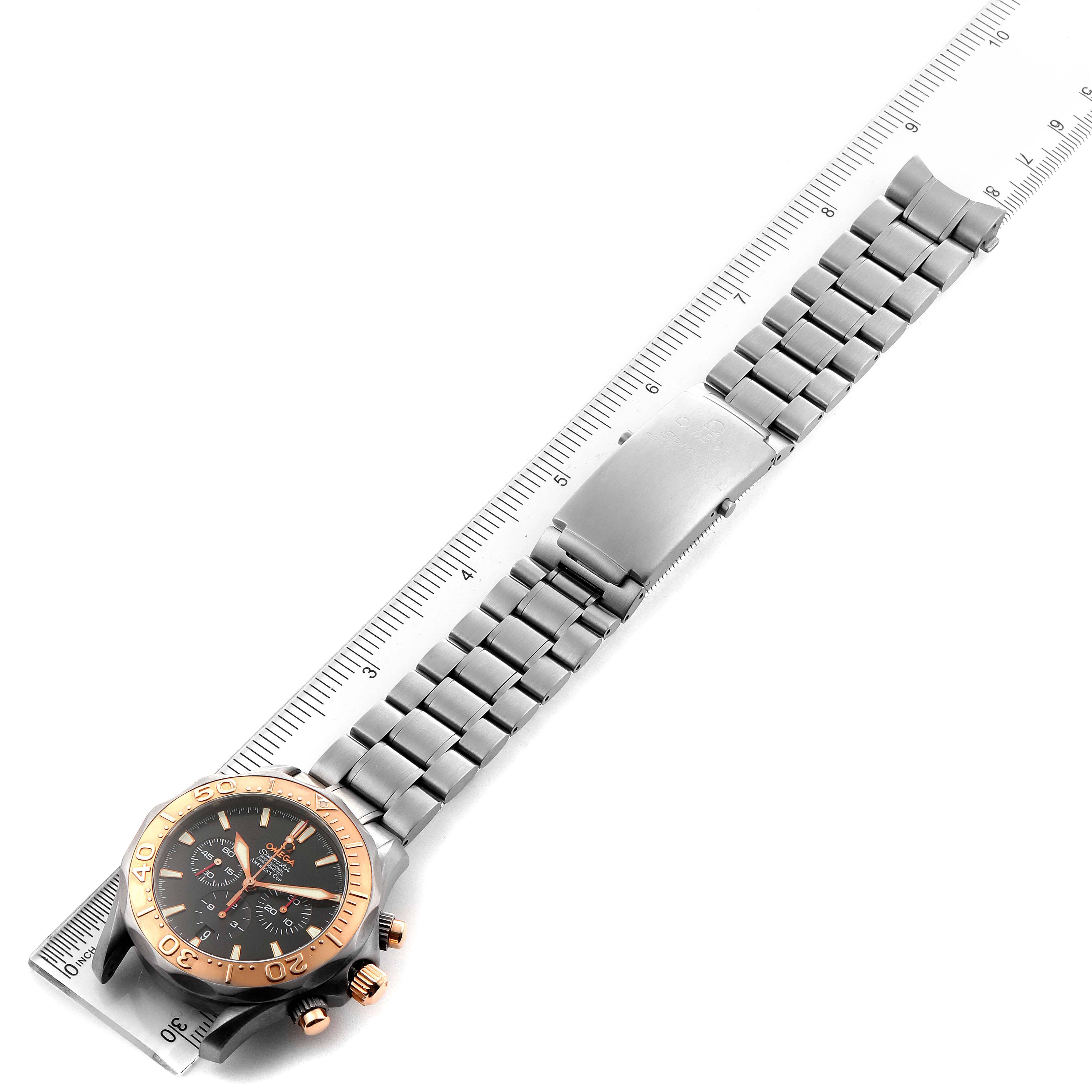 The image shows an Omega Seamaster 2294.50.00 Men's Titanium Black Dial 2294.50.00 Men's Titanium Black Dial watch with a steel and gold bracelet laid flat alongside a ruler for size reference.