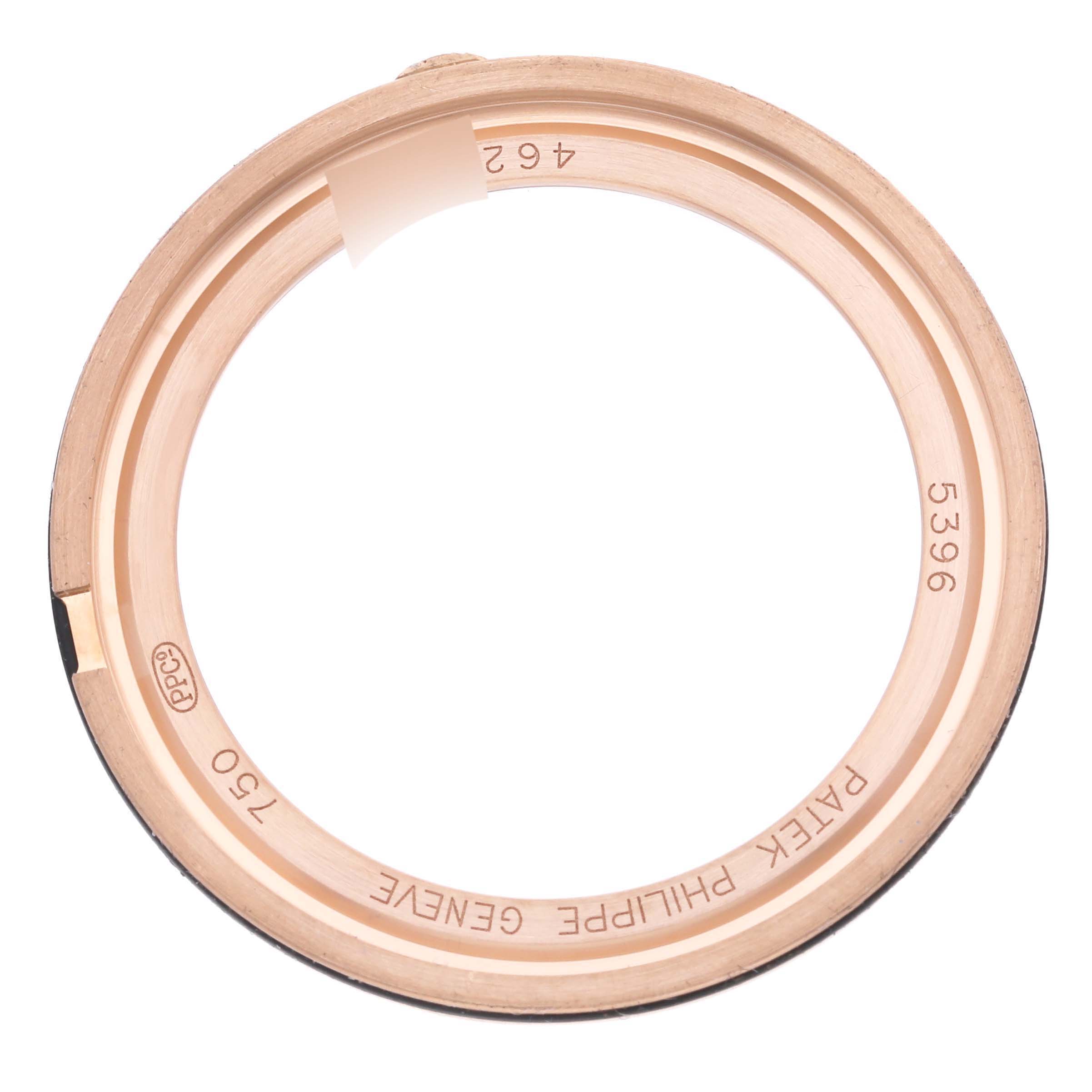 The image shows a Patek Philippe Complications 5396R-011 Men
s Rose Gold Silver Dial 5396R-011 Men
s Rose Gold Silver Dial model watch bezel, viewed from the top.