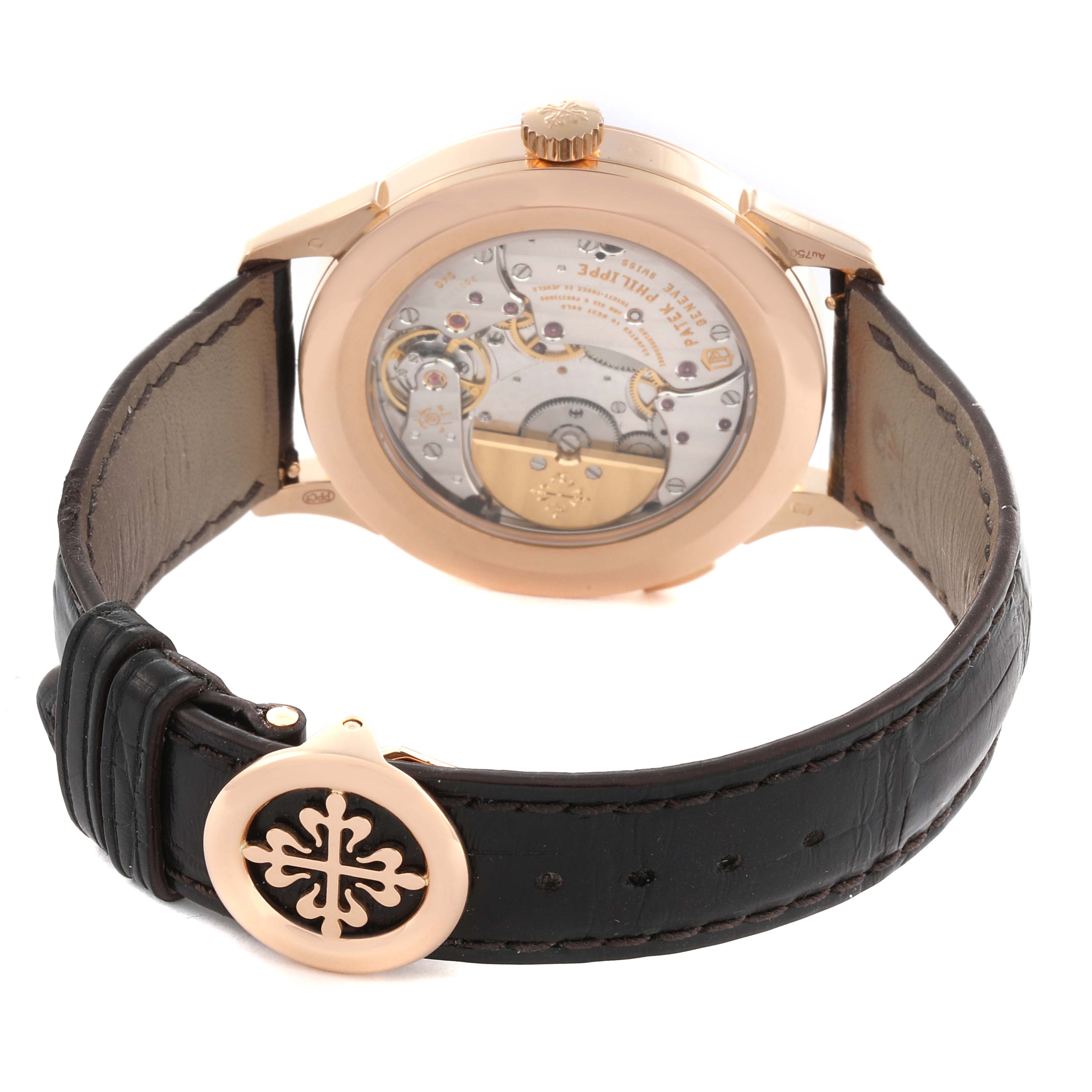 The watch shows the back view of the Patek Philippe Complications 5230R-001 Men's Rose Gold Silver Dial 5230R-001 Men's Rose Gold Silver Dial model, highlighting the movement and leather strap with clasp.