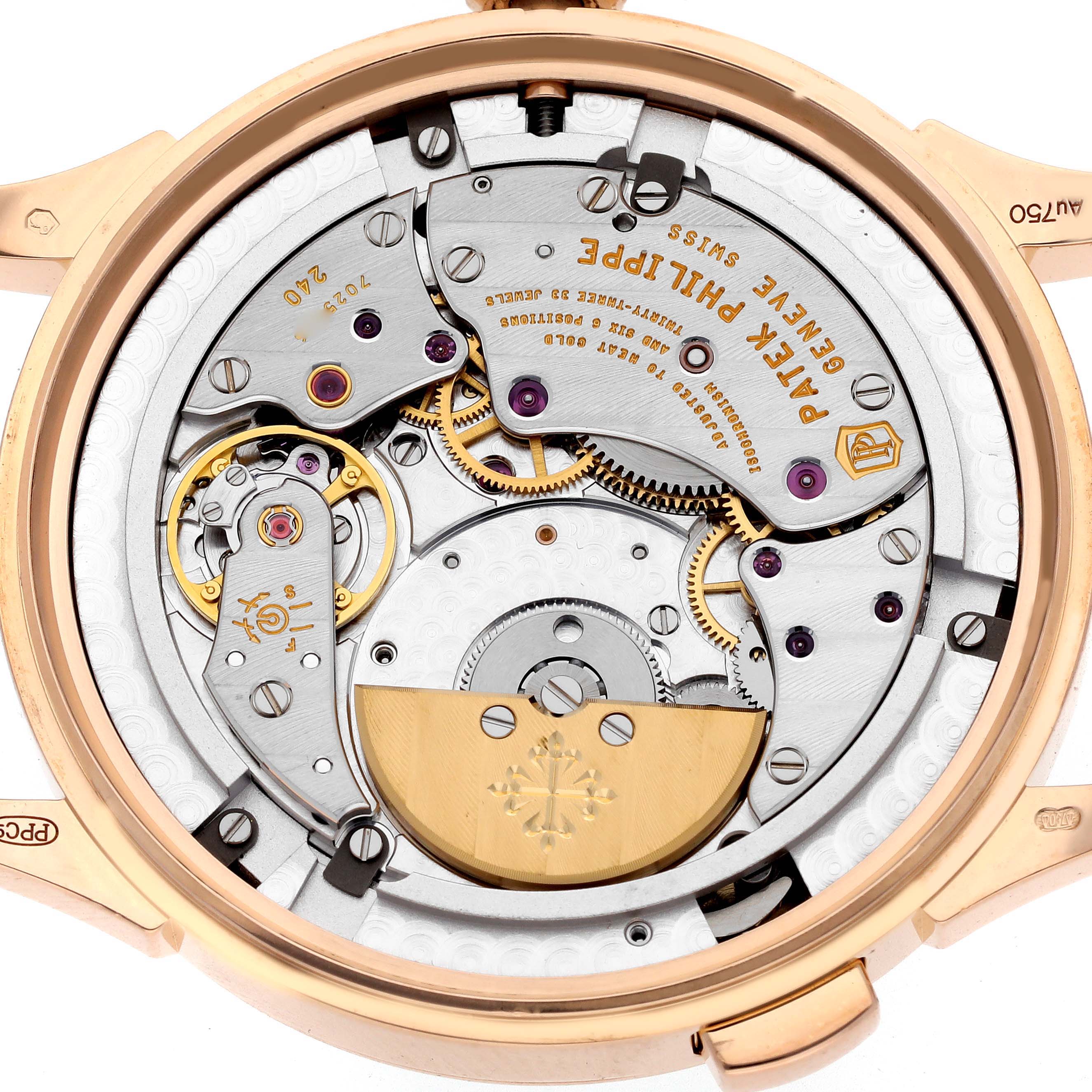 The image shows the back view of the Patek Philippe Complications 5230R-001 Men's Rose Gold Silver Dial 5230R-001 Men's Rose Gold Silver Dial watch, highlighting its intricate movement and gears.