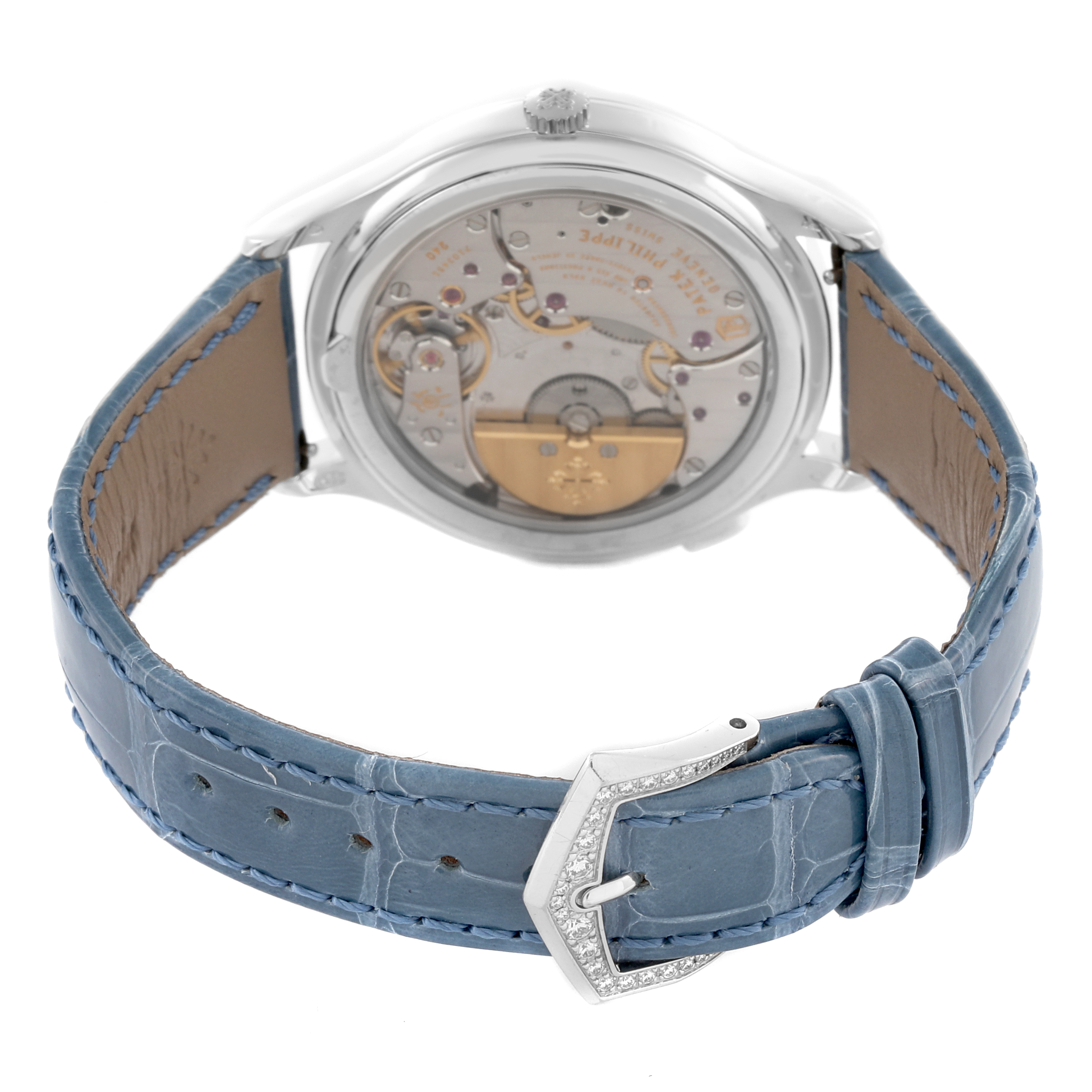 The Patek Philippe Complications 7130G-014 Men's White Gold Blue Dial 7130G-014 Men's White Gold Blue Dial watch is shown from the back, revealing its exposed movement and a blue leather strap.