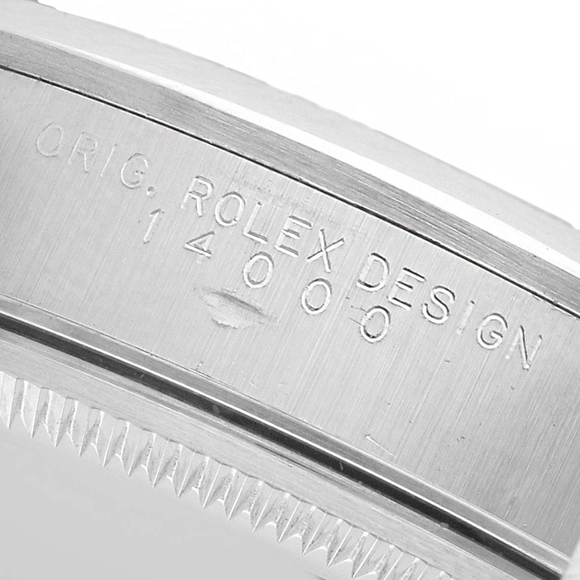 The image shows a close-up of the side of the Rolex Air-King 14000 Men's Stainless Steel Pink Dial watch case, featuring engraved design details.
