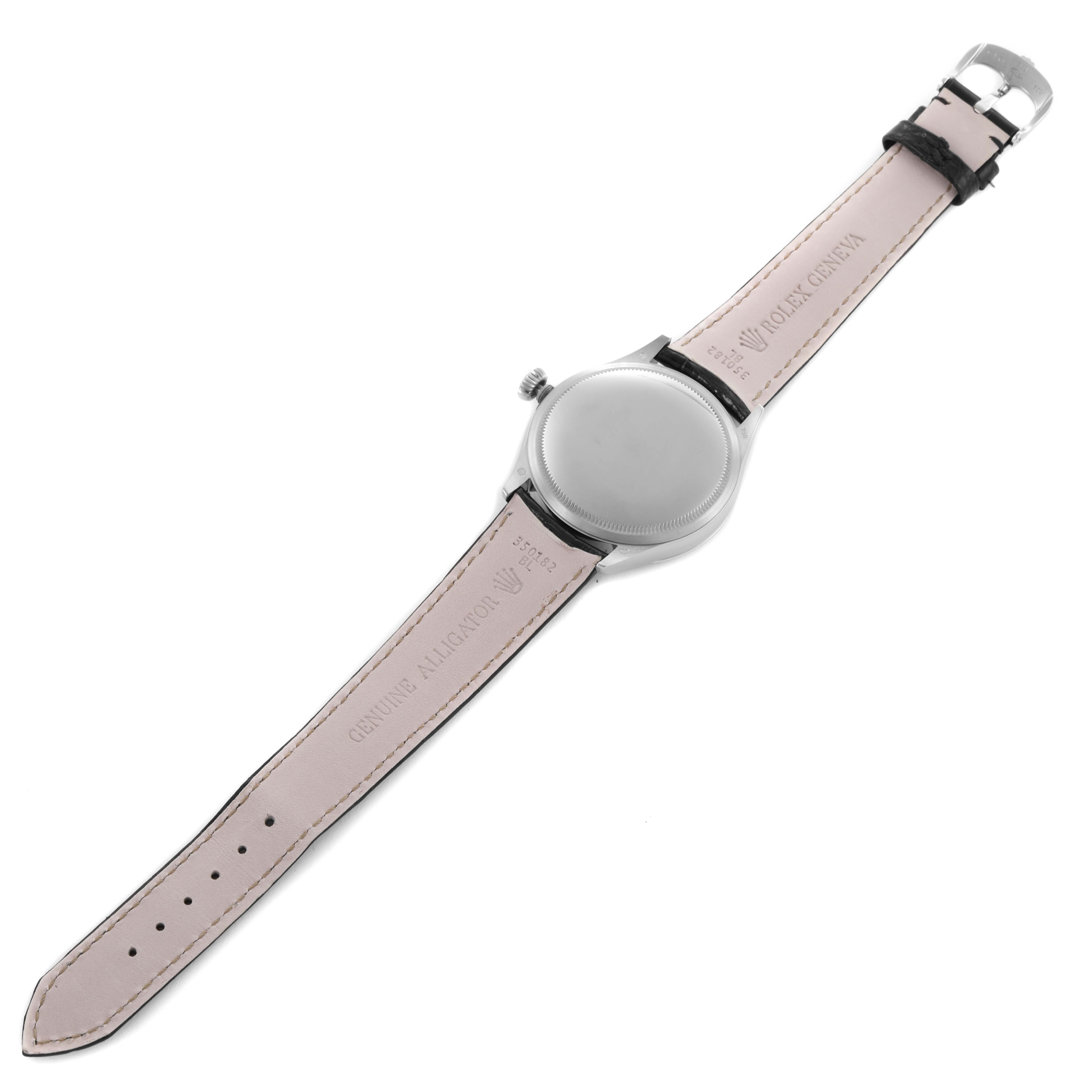 The Rolex Cellini 50509 Men's White Gold Black Dial 50509 Men's White Gold Black Dial watch is shown from the back, highlighting the leather strap and case back.