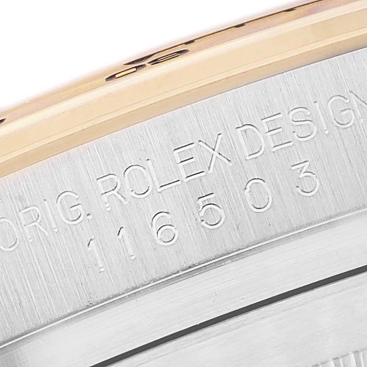 This image shows a close-up of the engraved serial number and design text on the case of a Rolex Daytona 116503 Men's Steel and Gold (two tone) White Dial 116503 Men's Steel and Gold (two tone) White Dial watch.