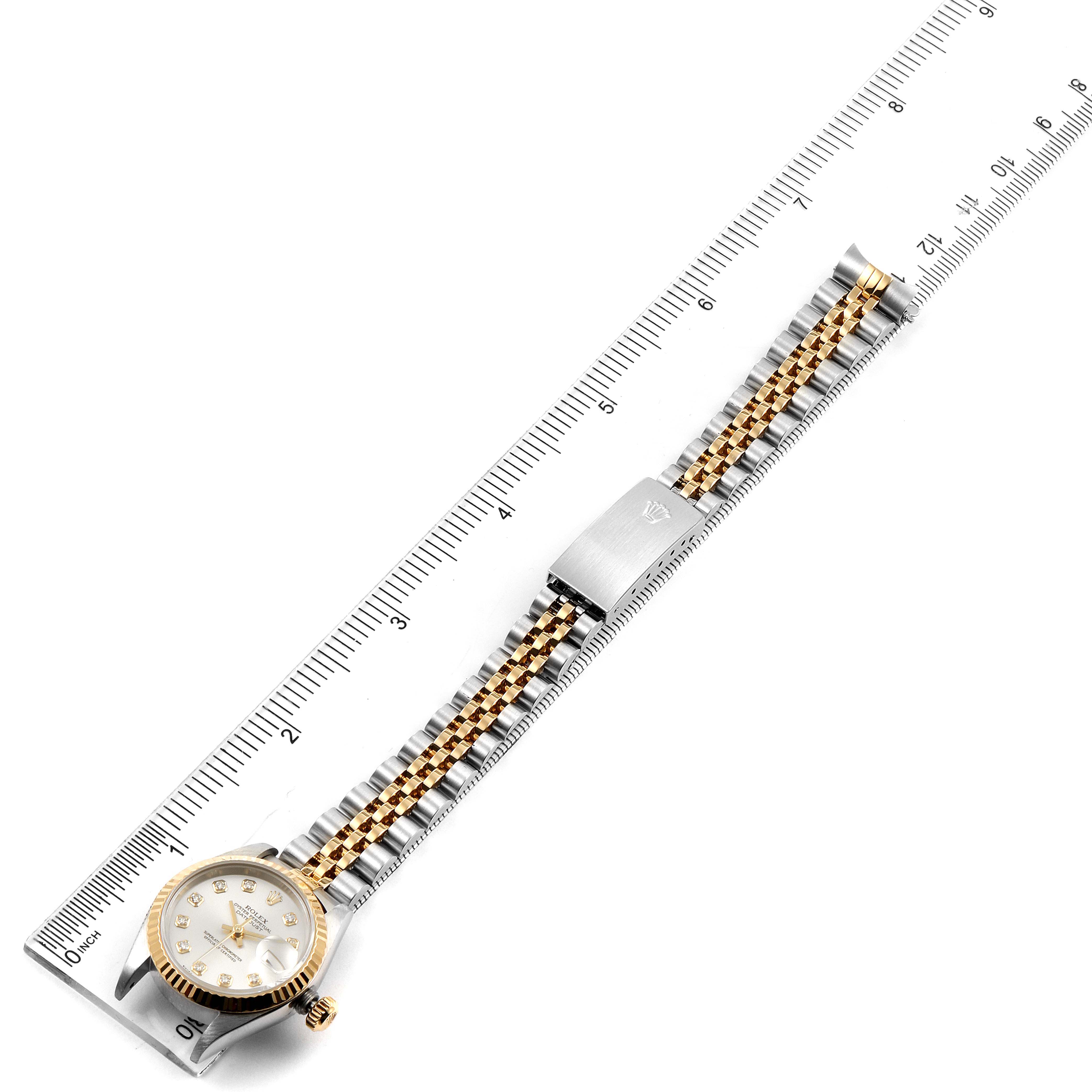 The Rolex Datejust 79173 Women's Steel and Gold (two tone) Silver Dial 79173 Women's Steel and Gold (two tone) Silver Dial watch is shown from above, displaying the dial, bezel, two-tone bracelet, and clasp, measured against a ruler.