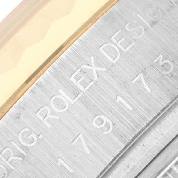 The image shows a close-up of the engraved side of the bezel on a Rolex Datejust 179173 Women's Steel and Gold (two tone) Silver Dial 179173 Women's Steel and Gold (two tone) Silver Dial watch.