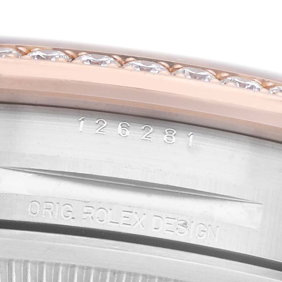 The image shows a close-up of the bezel and engraving on a Rolex Datejust 126281 Men's Steel and Gold (two tone) Pink Dial watch, highlighting diamonds and model number.
