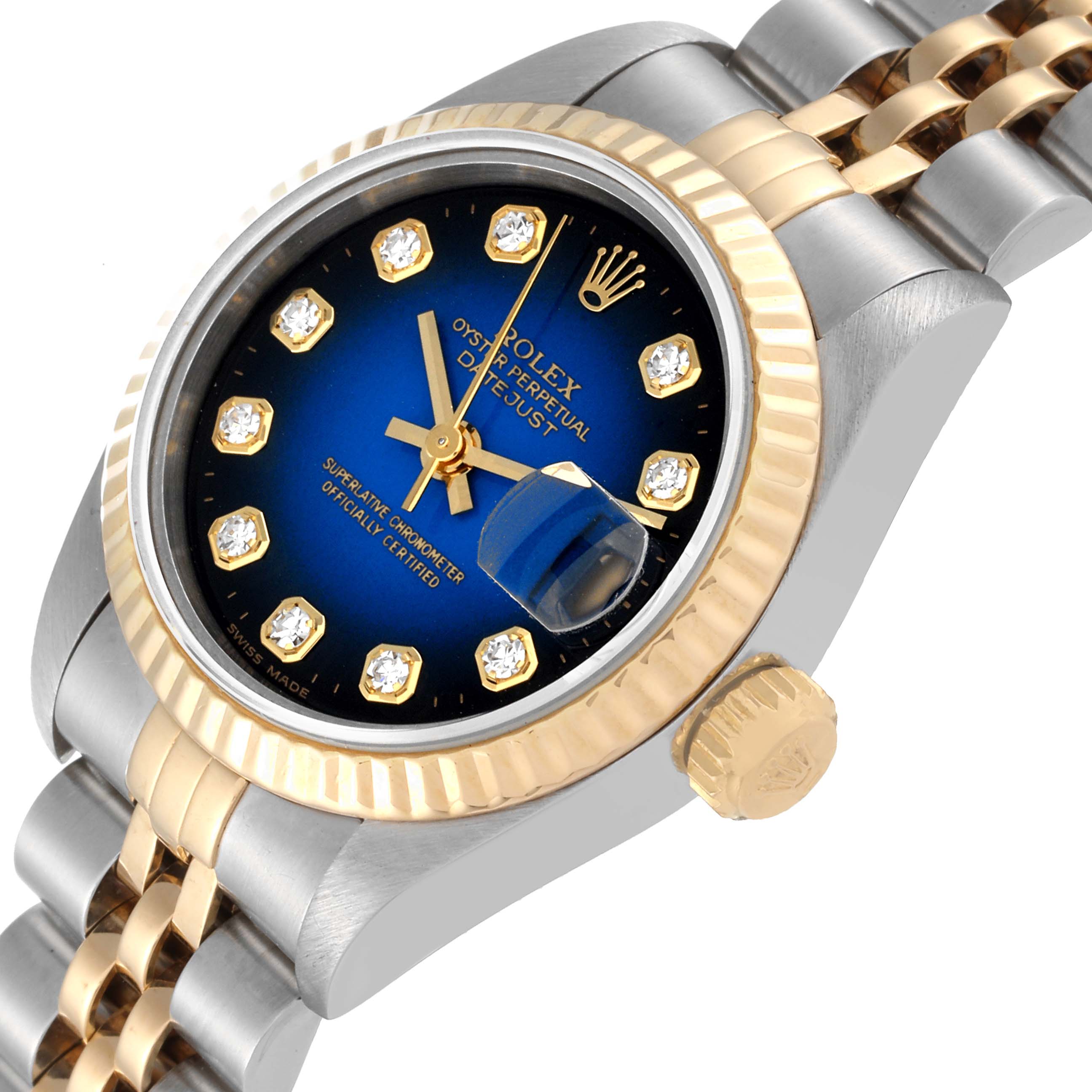 This image shows a Rolex Datejust 69173 Women's Steel and Gold (two tone) Blue Dial 69173 Women's Steel and Gold (two tone) Blue Dial watch at an angled close-up, highlighting its blue dial, fluted bezel, and two-tone bracelet.