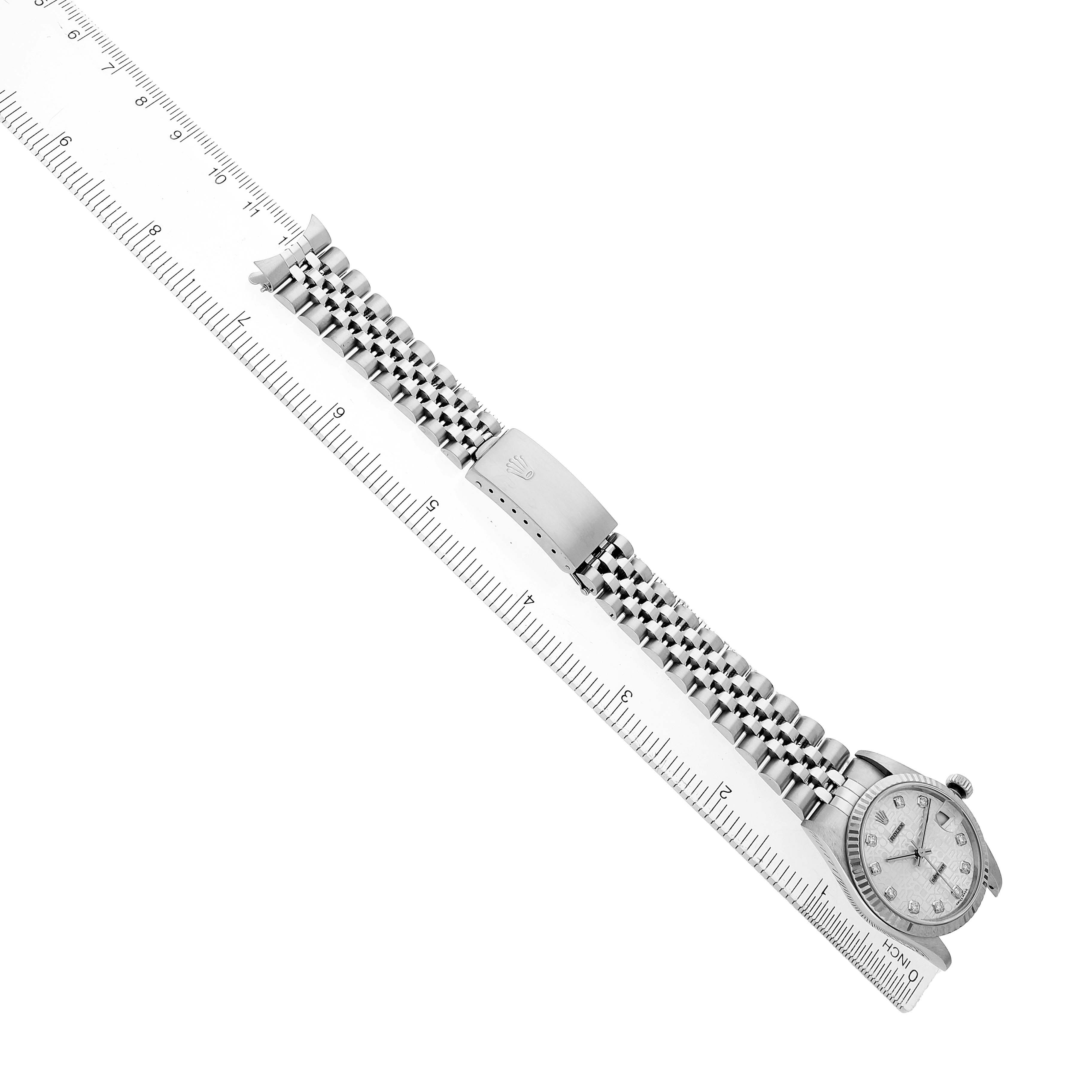 The image shows a Rolex Mid-Size 68274 Women's Stainless Steel Silver Dial watch at a diagonal angle, featuring the entire bracelet and clasp alongside a ruler for scale.
