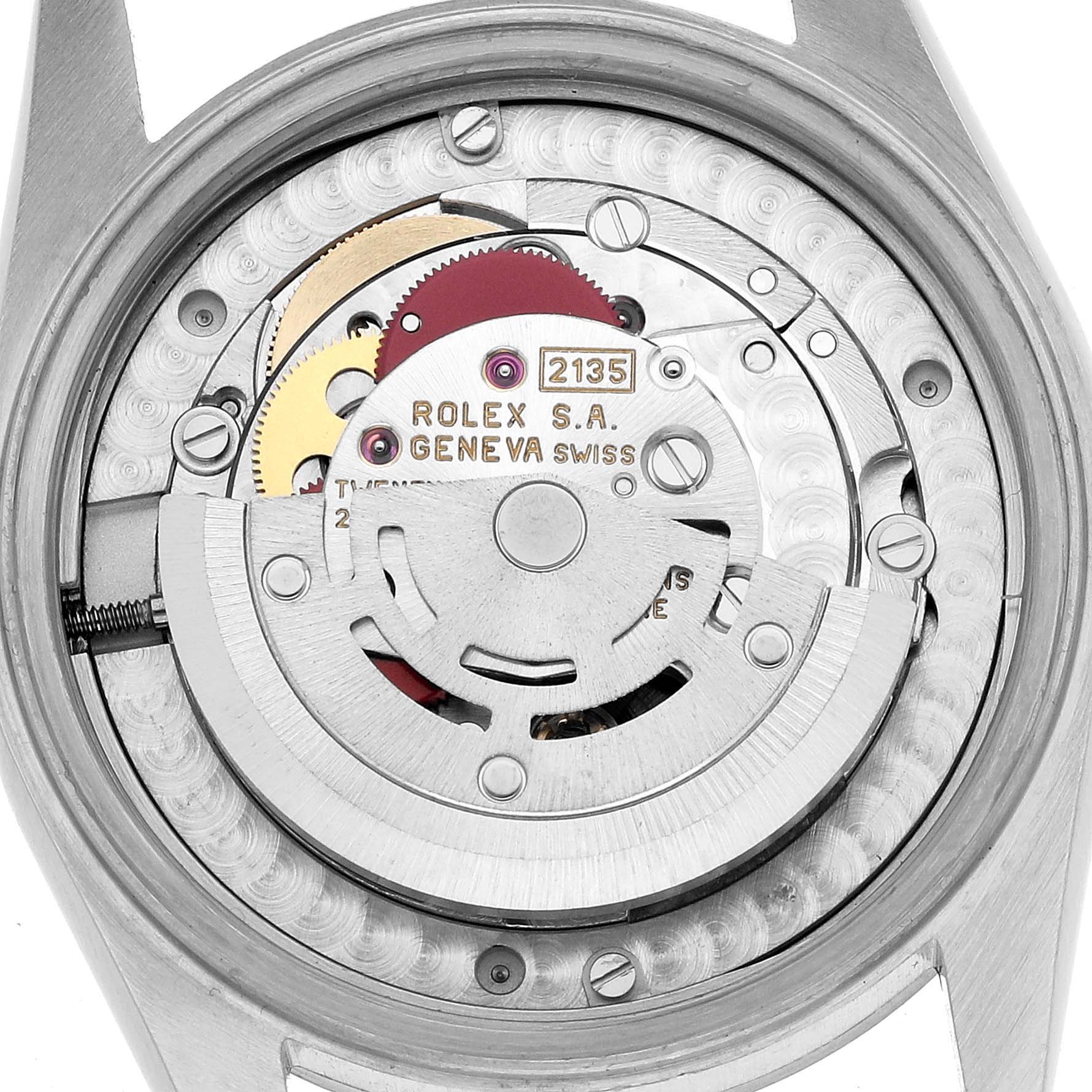 The image shows a detailed view of the movement inside a Rolex Mid-Size 68274 Women's Stainless Steel Silver Dial watch, highlighting the rotor and gears.