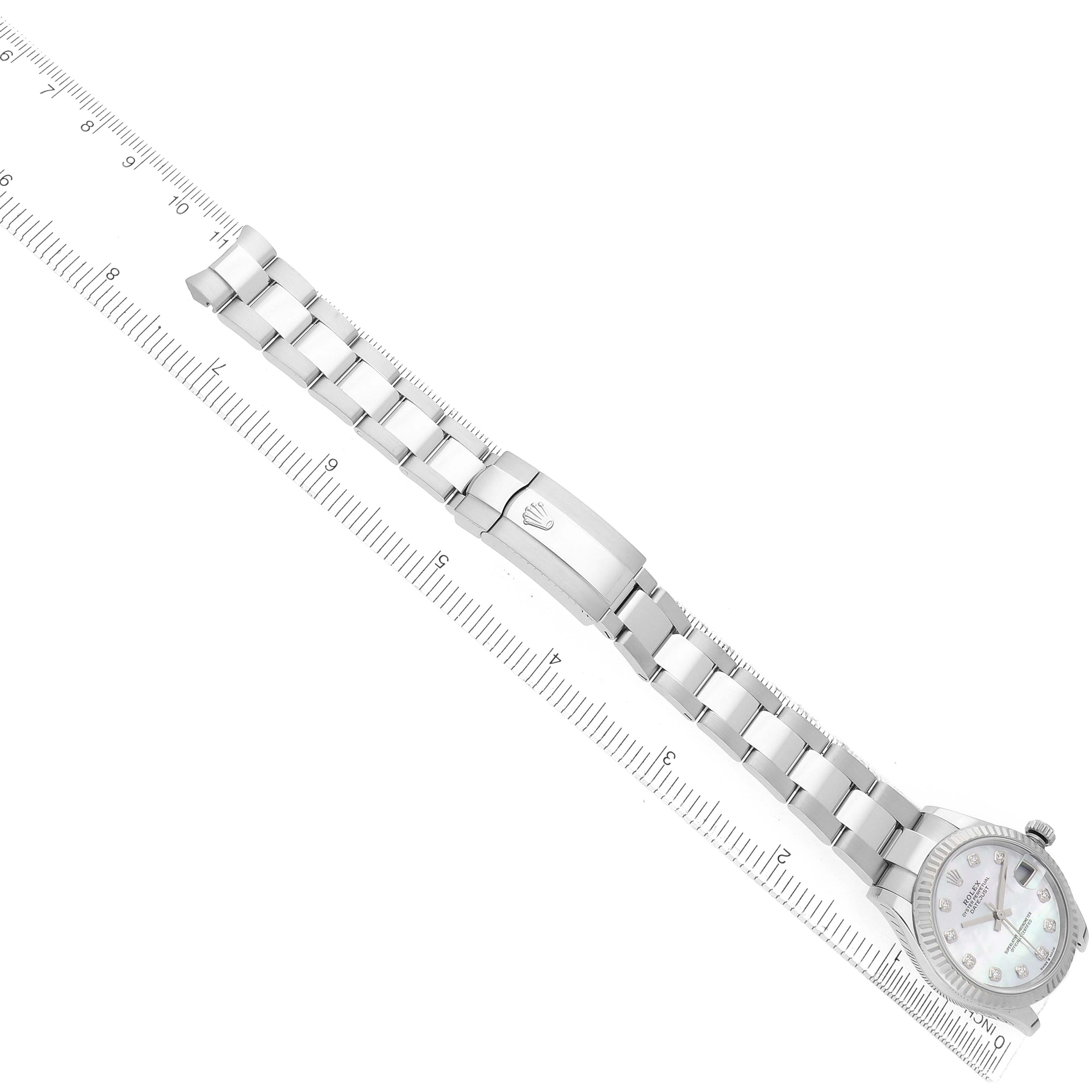 The image shows a side view of the Rolex Mid-Size 278274 Women's Stainless Steel Mother of Pearl Dial model watch, highlighting the bracelet and clasp on a ruler for size reference.