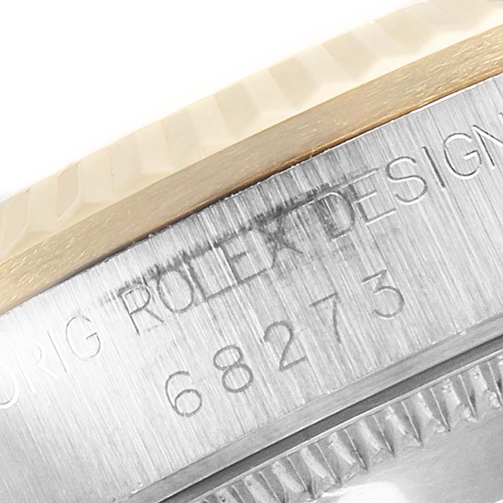 The image shows the model and serial number engraving on the side of a Rolex Mid-Size 68273 Women's Steel and Gold (two tone) White Dial 68273 Women's Steel and Gold (two tone) White Dial watch case.