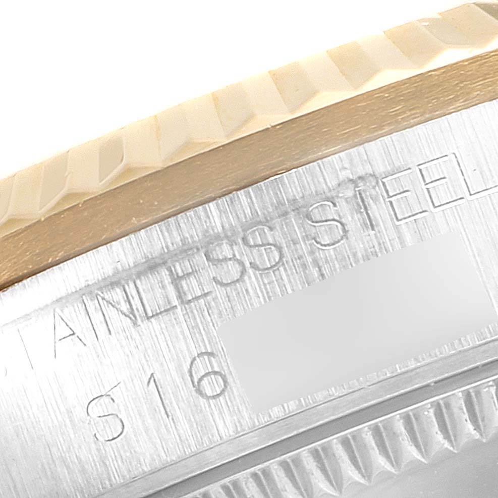 This close-up image shows a side angle of a Rolex Mid-Size 68273 Women's Steel and Gold (two tone) White Dial 68273 Women's Steel and Gold (two tone) White Dial model watch, focusing on the bezel and part of the casing with the "STAINLESS STEEL" engraving.