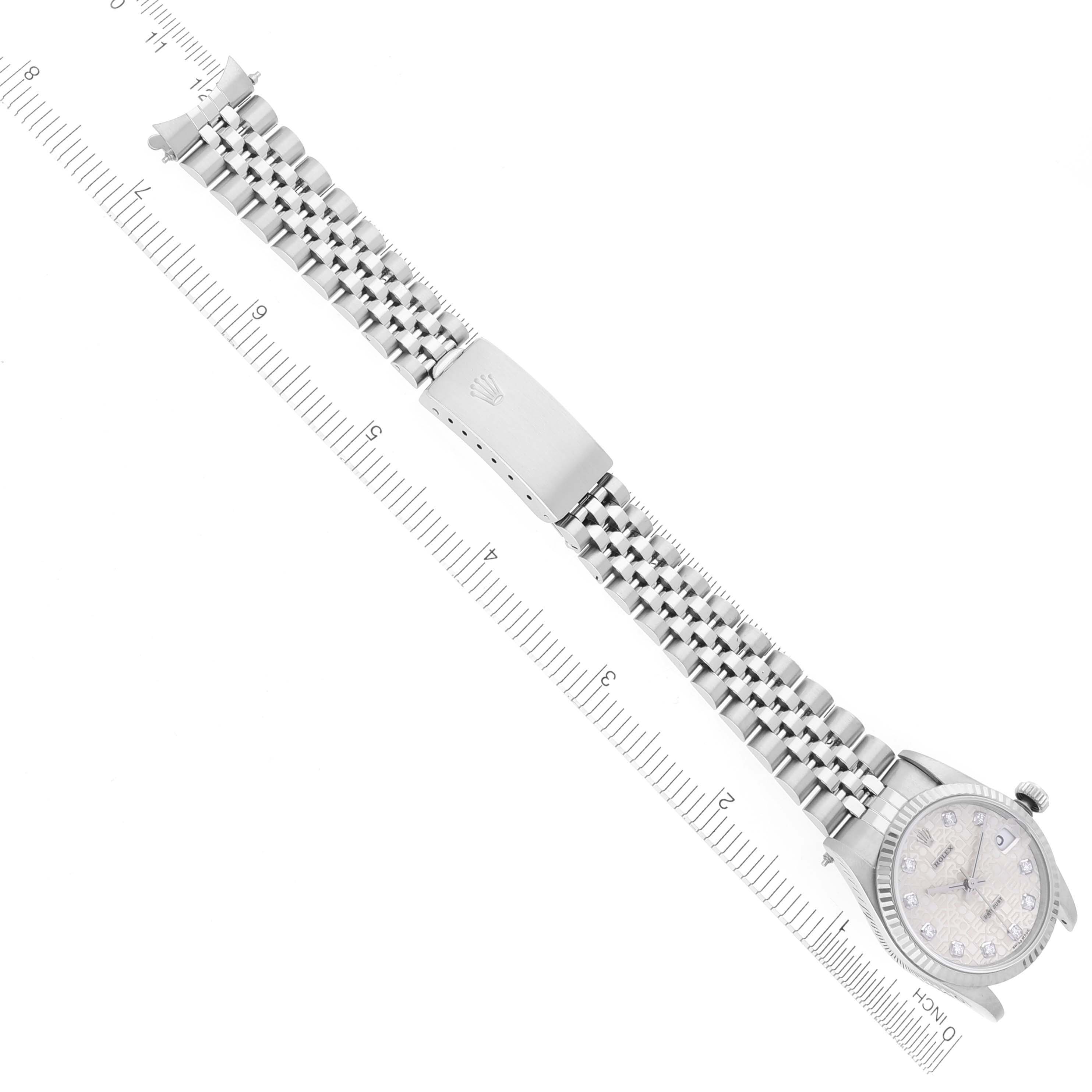 The Mid-Size Rolex watch is shown from a top-down angle, highlighting the bracelet and clasp.