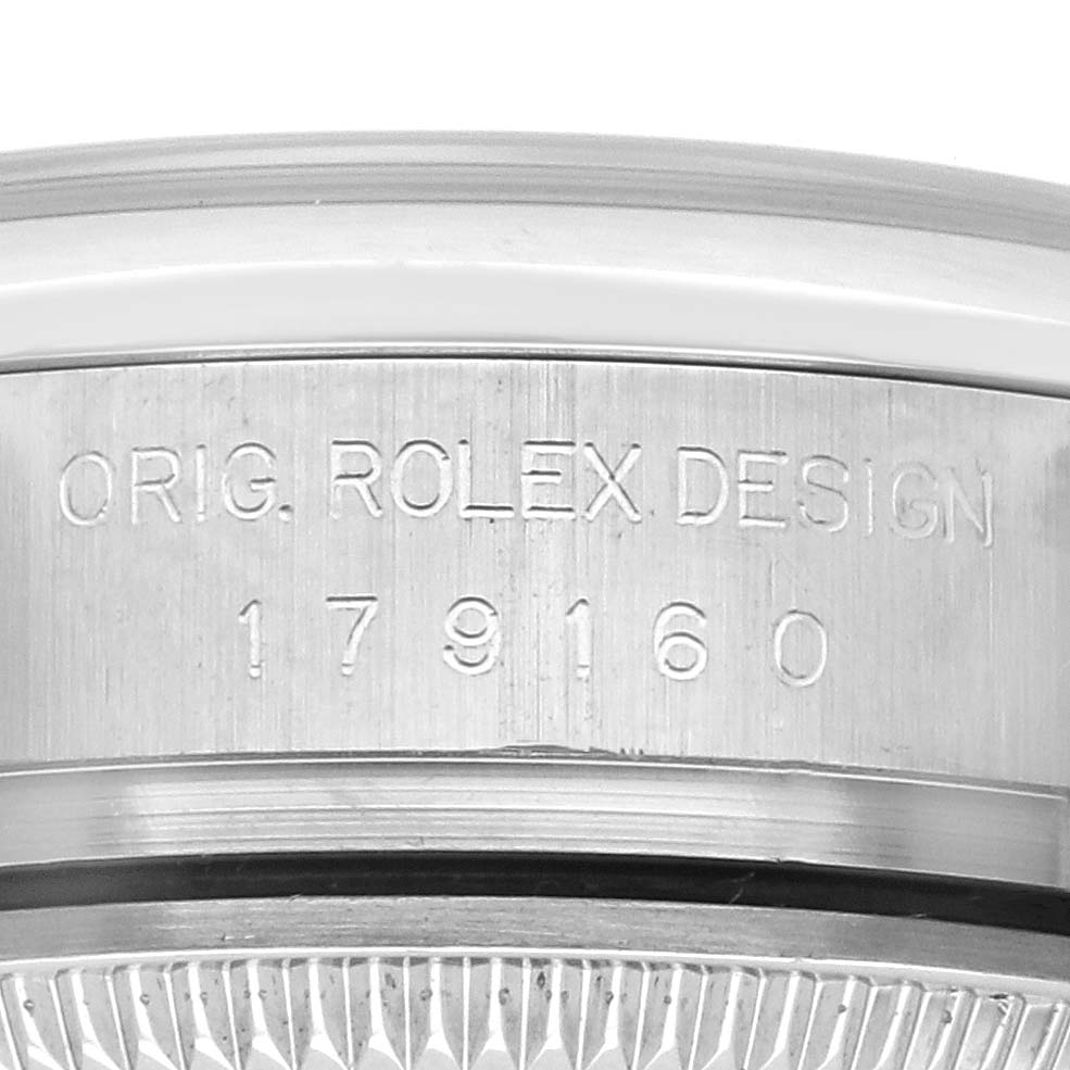 The image shows a close-up of the side of a Rolex Datejust 179160 Women's Stainless Steel Pink Dial 179160 Women's Stainless Steel Pink Dial case, featuring the serial and model number engraving.