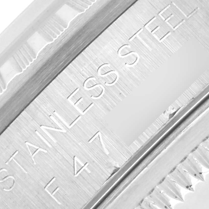 The image shows a close-up of the stainless steel engraving on the side of the Rolex Datejust 16220 Men's Stainless Steel Silver Dial 16220 Men's Stainless Steel Silver Dial watch case.