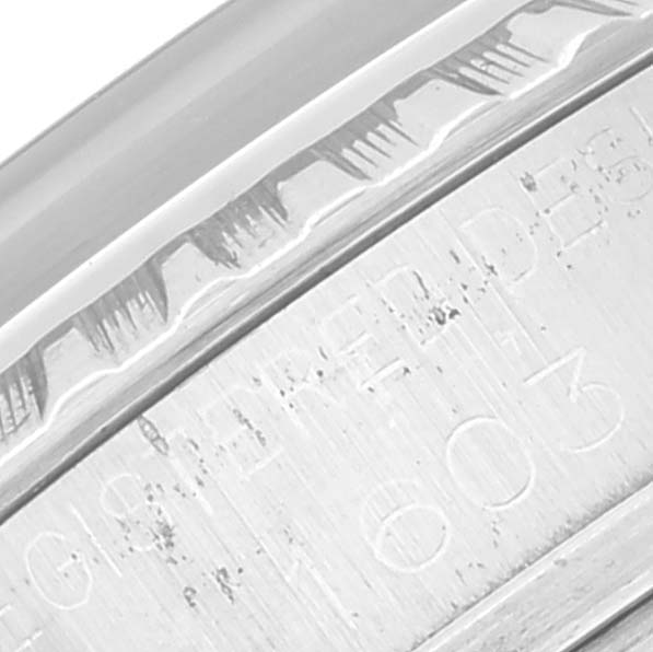 This close-up shows the side of the bezel and engraved serial number on the case of the Rolex Vintage Collection 1603 Men's Stainless Steel Silver Dial 1603 Men's Stainless Steel Silver Dial model.