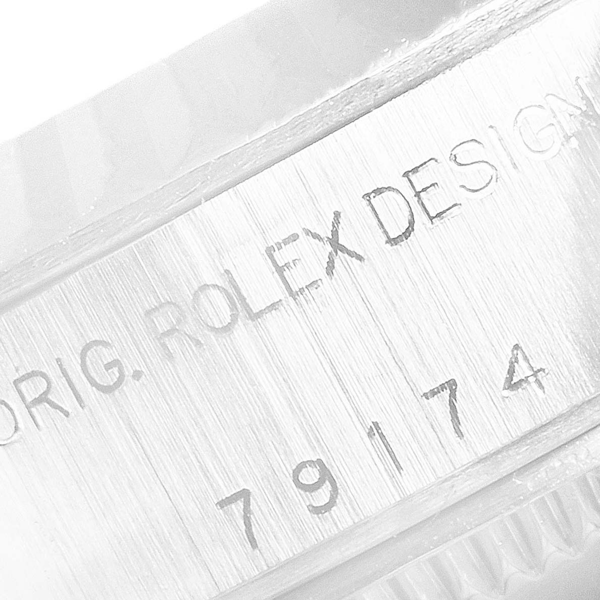 The image shows a close-up of the model number "79174" and the engraving "ORIG. ROLEX DESIGN" on a Datejust watch by Rolex.