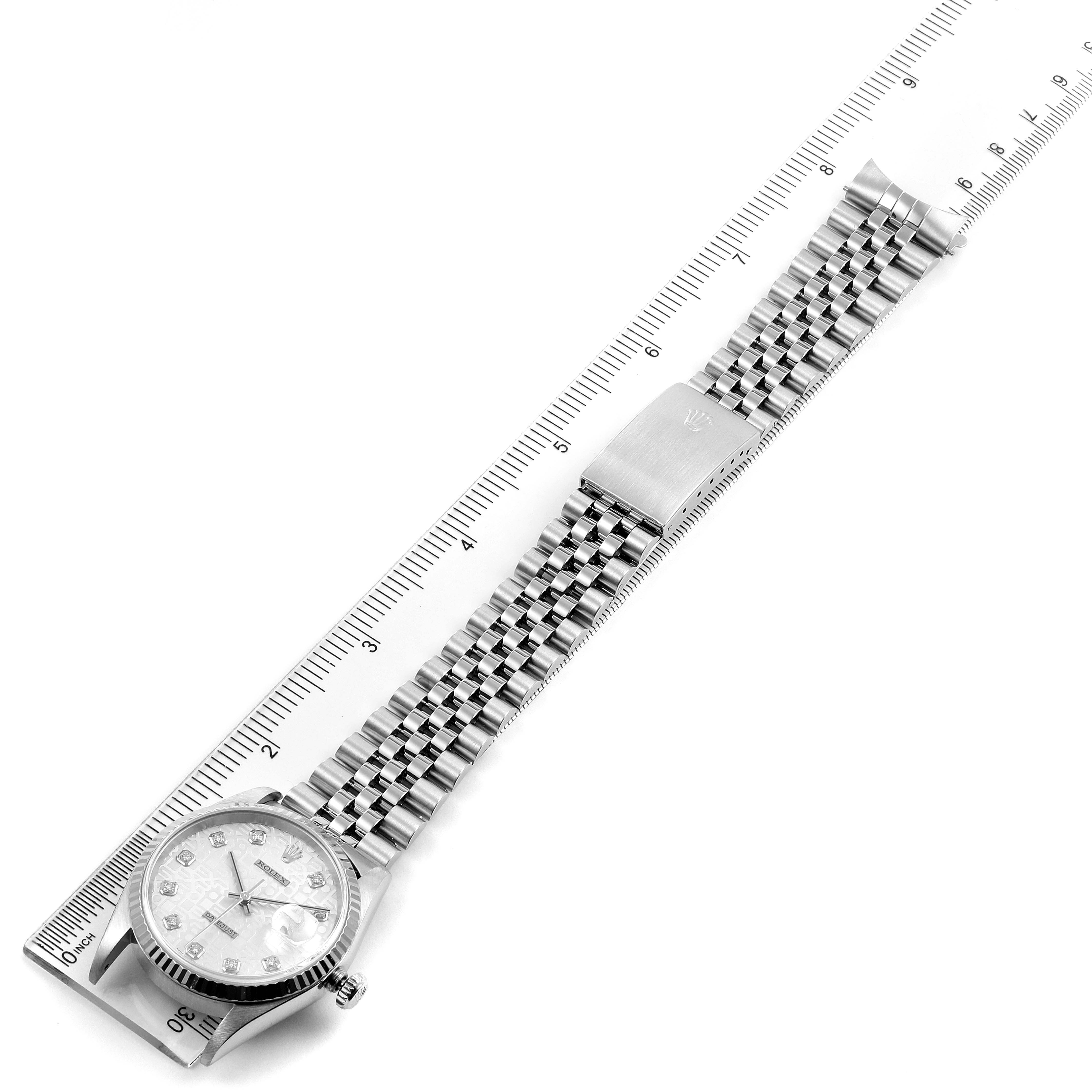 This image shows a Rolex Datejust 16234 Men's Stainless Steel Silver Dial 16234 Men's Stainless Steel Silver Dial watch laid flat next to a ruler, displaying the face, case, and metal bracelet.