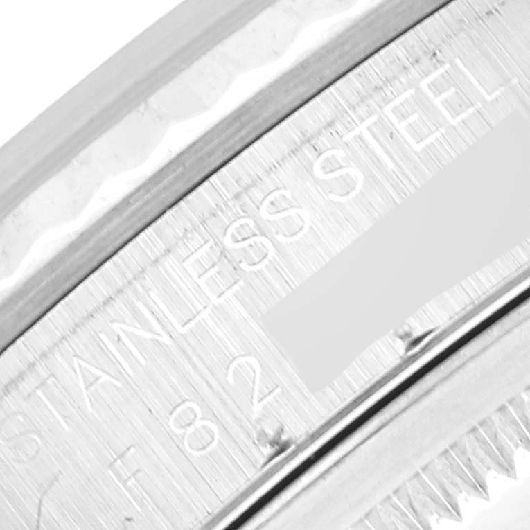 This image shows an up-close view of the bezel and part of the case back of a Rolex Datejust 16234 Men's Stainless Steel Silver Dial 16234 Men's Stainless Steel Silver Dial watch, featuring the "STAINLESS STEEL" engraving.