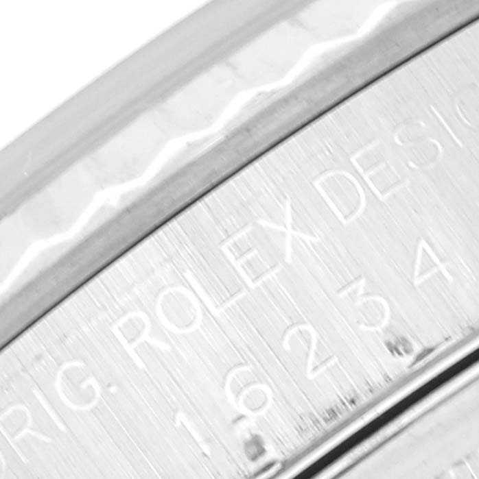 This close-up image shows the engraved edge of a Rolex Datejust 16234 Men's Stainless Steel Silver Dial 16234 Men's Stainless Steel Silver Dial watch case.