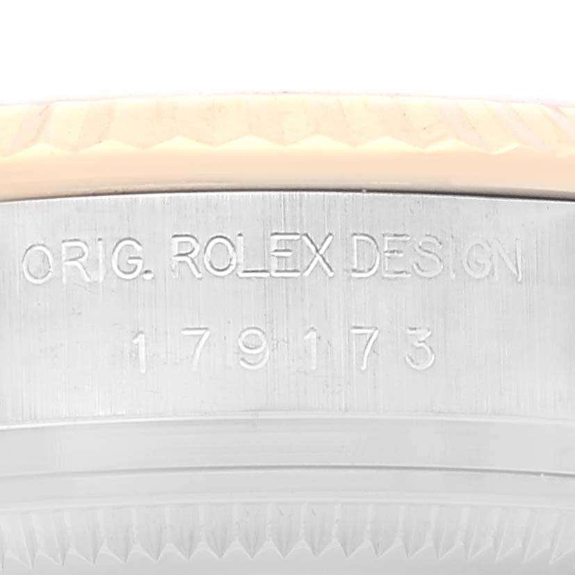 This is a close-up shot of the side of the Rolex Datejust 179173 Women's Steel and Gold (two tone) Silver Dial 179173 Women's Steel and Gold (two tone) Silver Dial watch case, showing the inscription and model number.