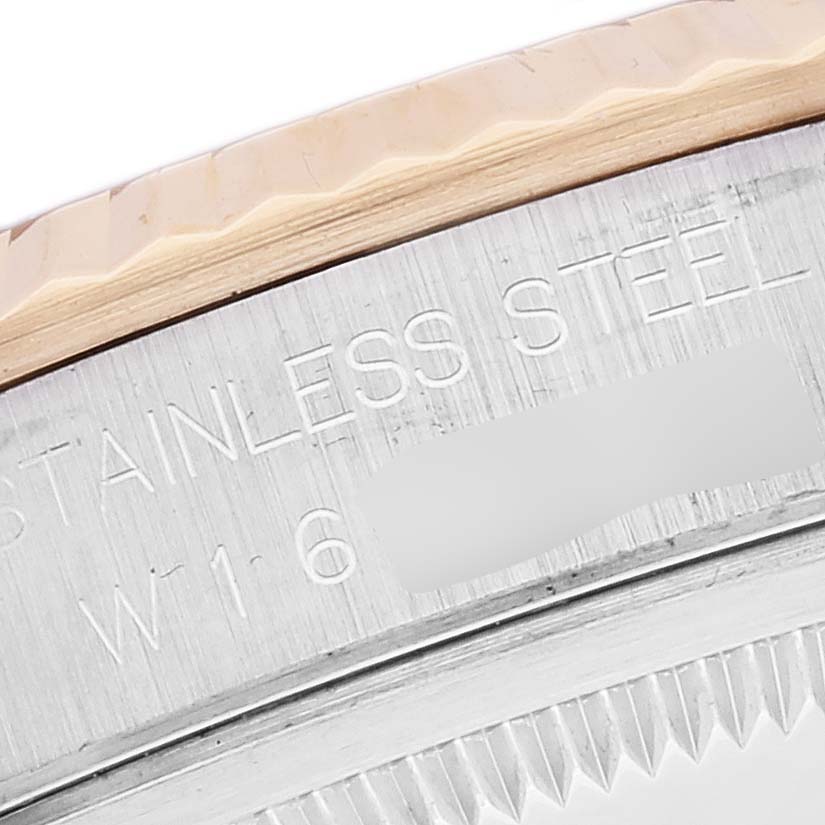 This close-up image shows the bezel edge and part of the side of a Rolex Datejust 16233 Men's Steel and Gold (two tone) Black Dial 16233 Men's Steel and Gold (two tone) Black Dial watch with "STAINLESS STEEL" text.
