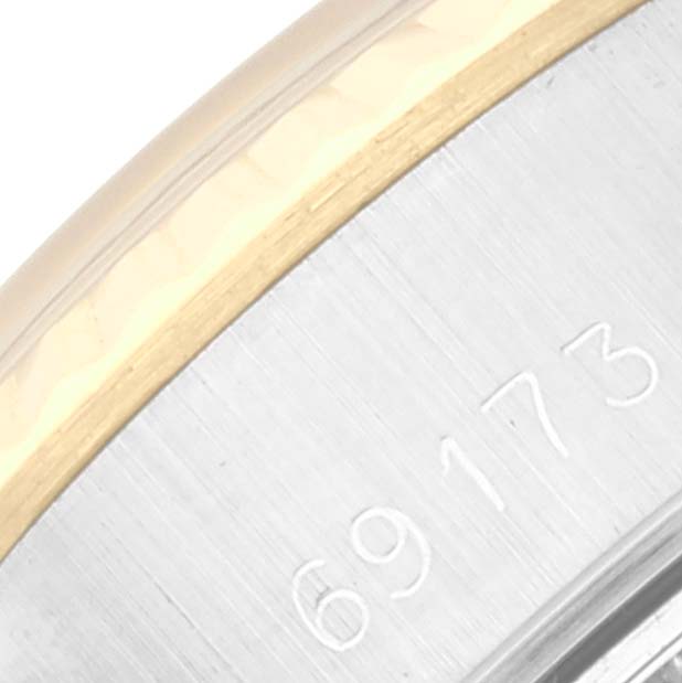This close-up image shows a partial view of the bezel and caseback with engraving on a Rolex Datejust 69173 Women's Steel and Gold (two tone) Champagne Dial 69173 Women's Steel and Gold (two tone) Champagne Dial model.