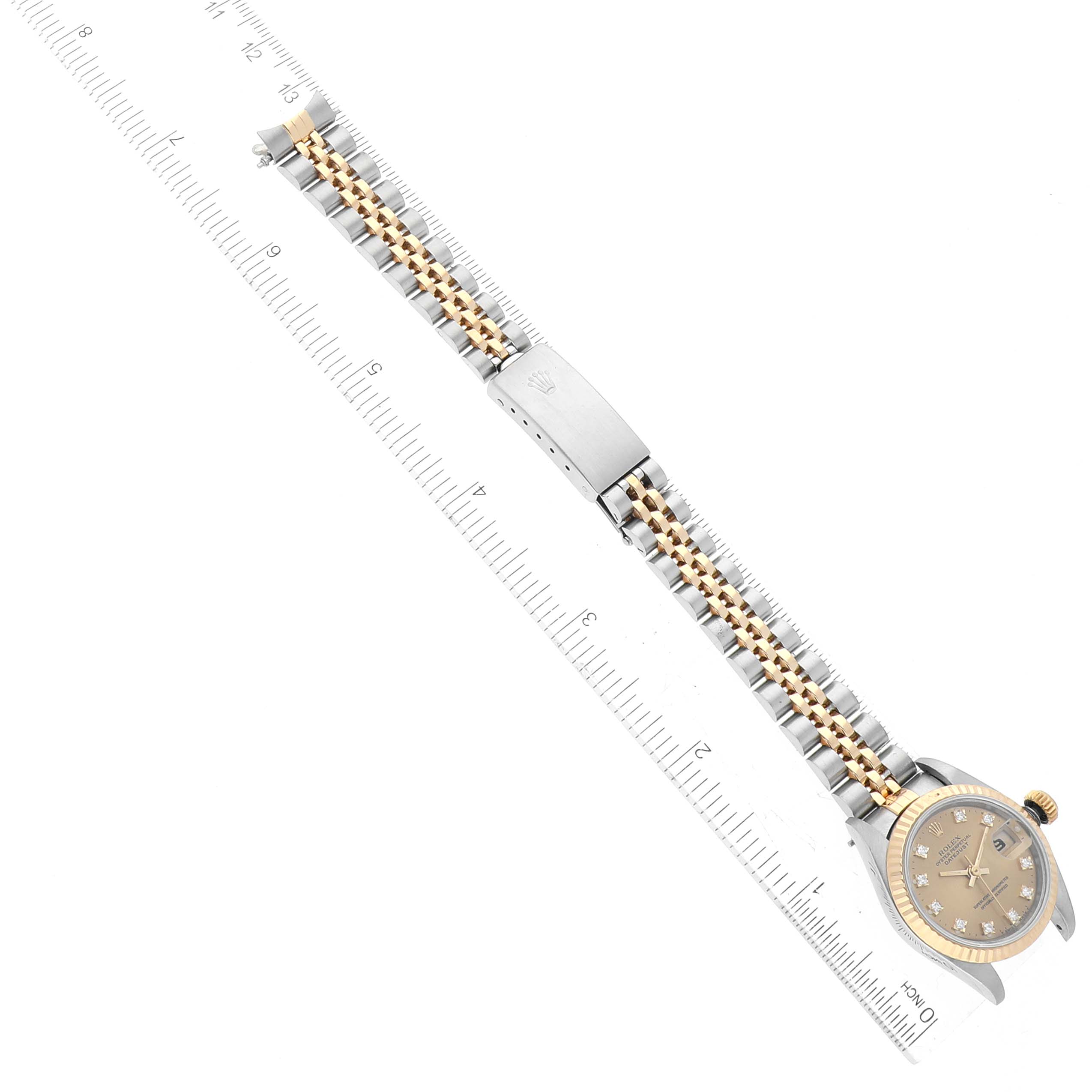 The image shows a Rolex Datejust 69173 Women's Steel and Gold (two tone) Champagne Dial 69173 Women's Steel and Gold (two tone) Champagne Dial watch laid flat with the bracelet extended alongside a ruler for measurement.