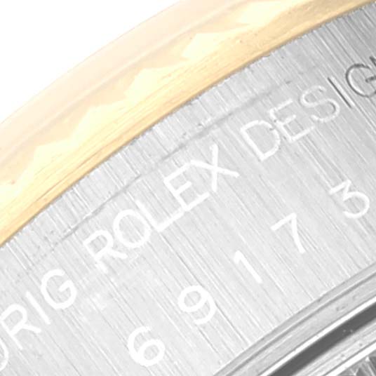 The image shows a close-up of the case side, with the Rolex Datejust 69173 Women's Steel and Gold (two tone) Champagne Dial 69173 Women's Steel and Gold (two tone) Champagne Dial model and serial number engraving visible.