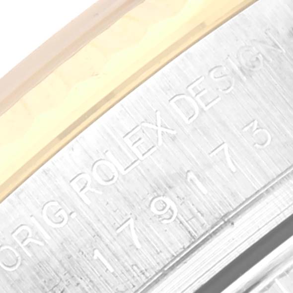 This image shows a side angle of a Rolex Datejust 179173 Women's Steel and Gold (two tone) Beige Dial 179173 Women's Steel and Gold (two tone) Beige Dial watch, highlighting the engraved serial number and "ROLEX DESIGN" text.