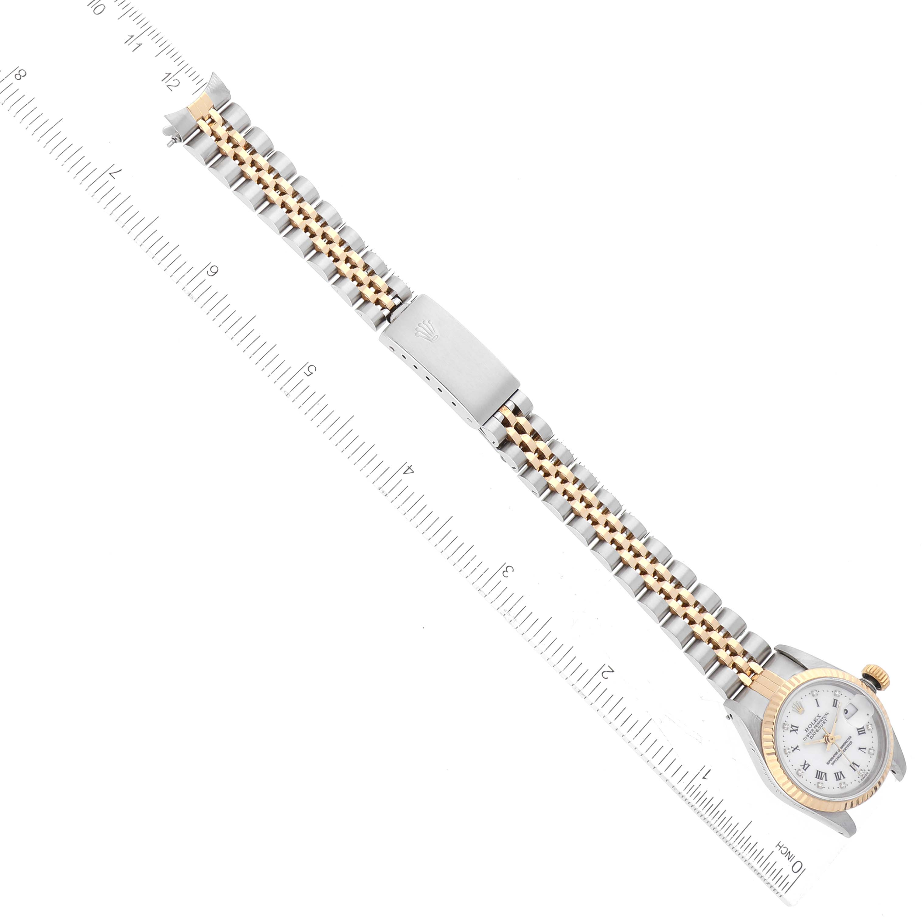 The photo shows the Rolex Datejust 69173G Women's Steel and Gold (two tone) White Dial 69173G Women's Steel and Gold (two tone) White Dial watch from a top-down angle, focusing on the bracelet and clasp.