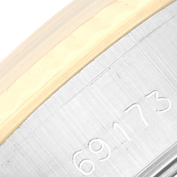 This close-up shows part of the bezel and engraved case of a Rolex Datejust 69173G Women's Steel and Gold (two tone) White Dial 69173G Women's Steel and Gold (two tone) White Dial model with the reference number 69173 visible.