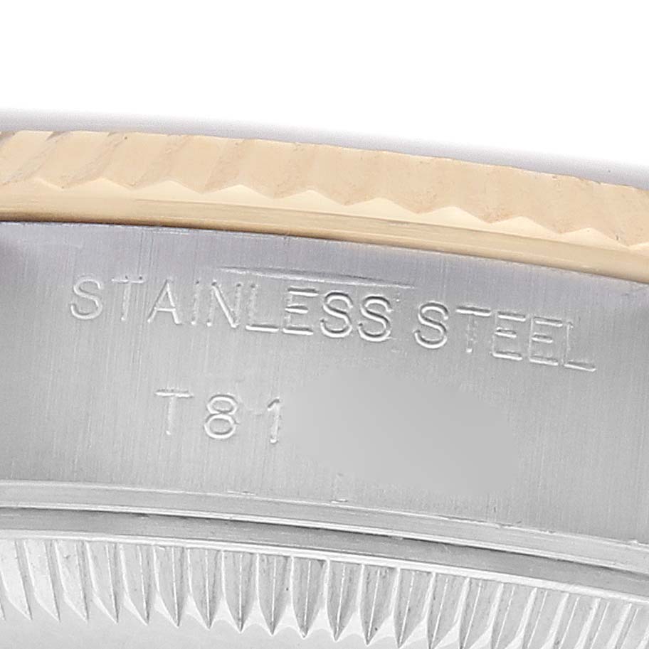 The image shows a close-up of the bezel and inner case of a Rolex Datejust 69173 Women's Steel and Gold (two tone) White Dial watch, highlighting the "STAINLESS STEEL" engraving.