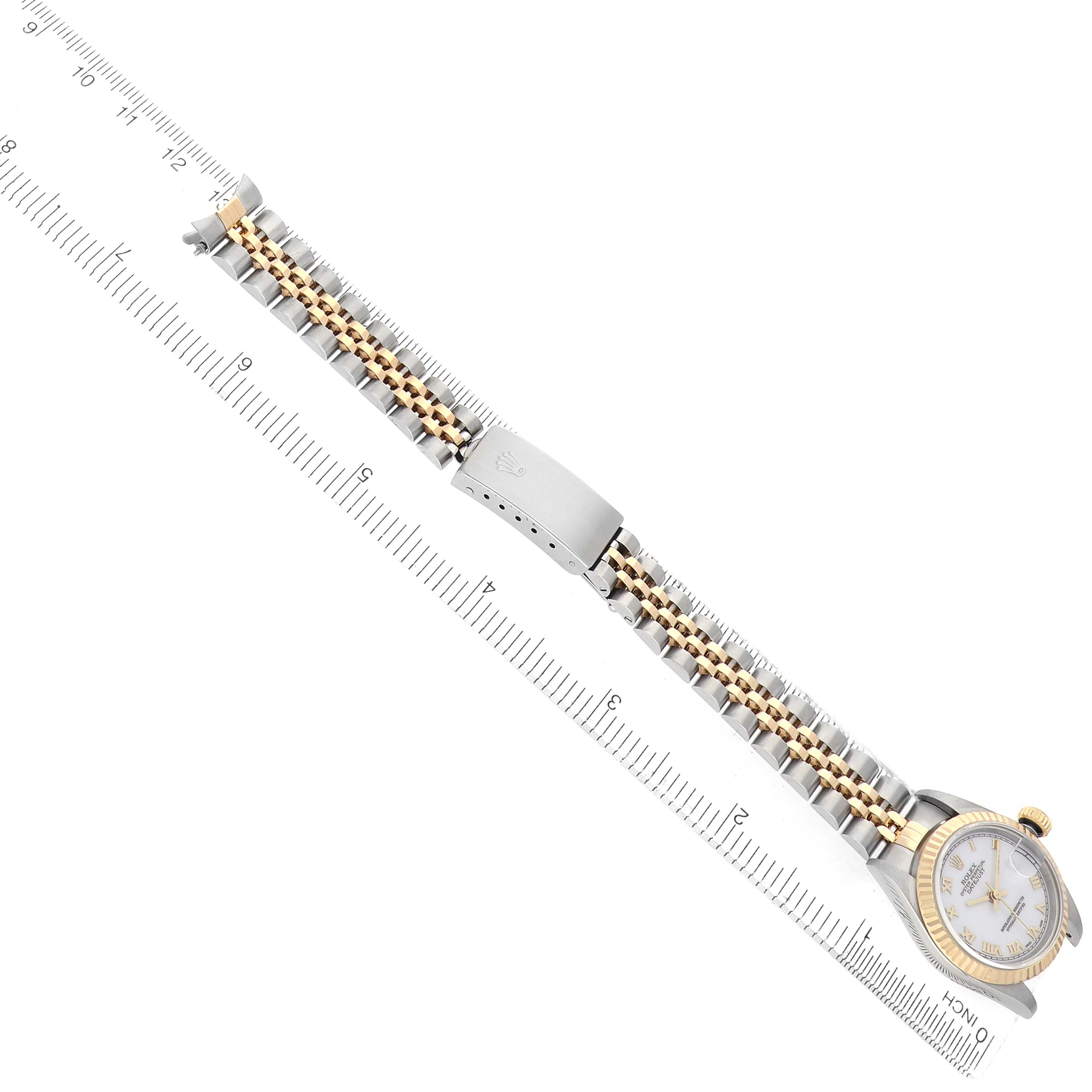 The Rolex Datejust 69173 Women's Steel and Gold (two tone) White Dial is shown diagonally with the full bracelet and clasp visible, aligned with a measuring ruler.