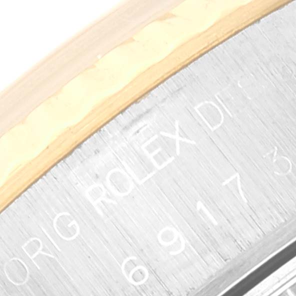 This close-up image shows the side engraving of the Rolex Datejust 69173 Women's Steel and Gold (two tone) White Dial 69173 Women's Steel and Gold (two tone) White Dial model's watch case.