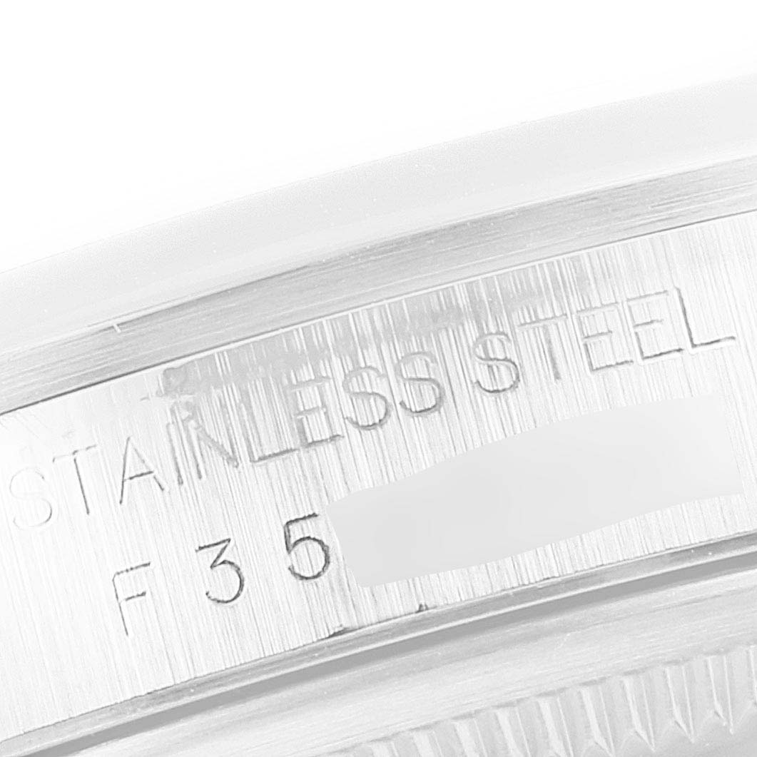 This close-up image focuses on the engraved "STAINLESS STEEL" text and part of the serial number on the Rolex Datejust 16200 Men's Stainless Steel White Dial 16200 Men's Stainless Steel White Dial watch case.