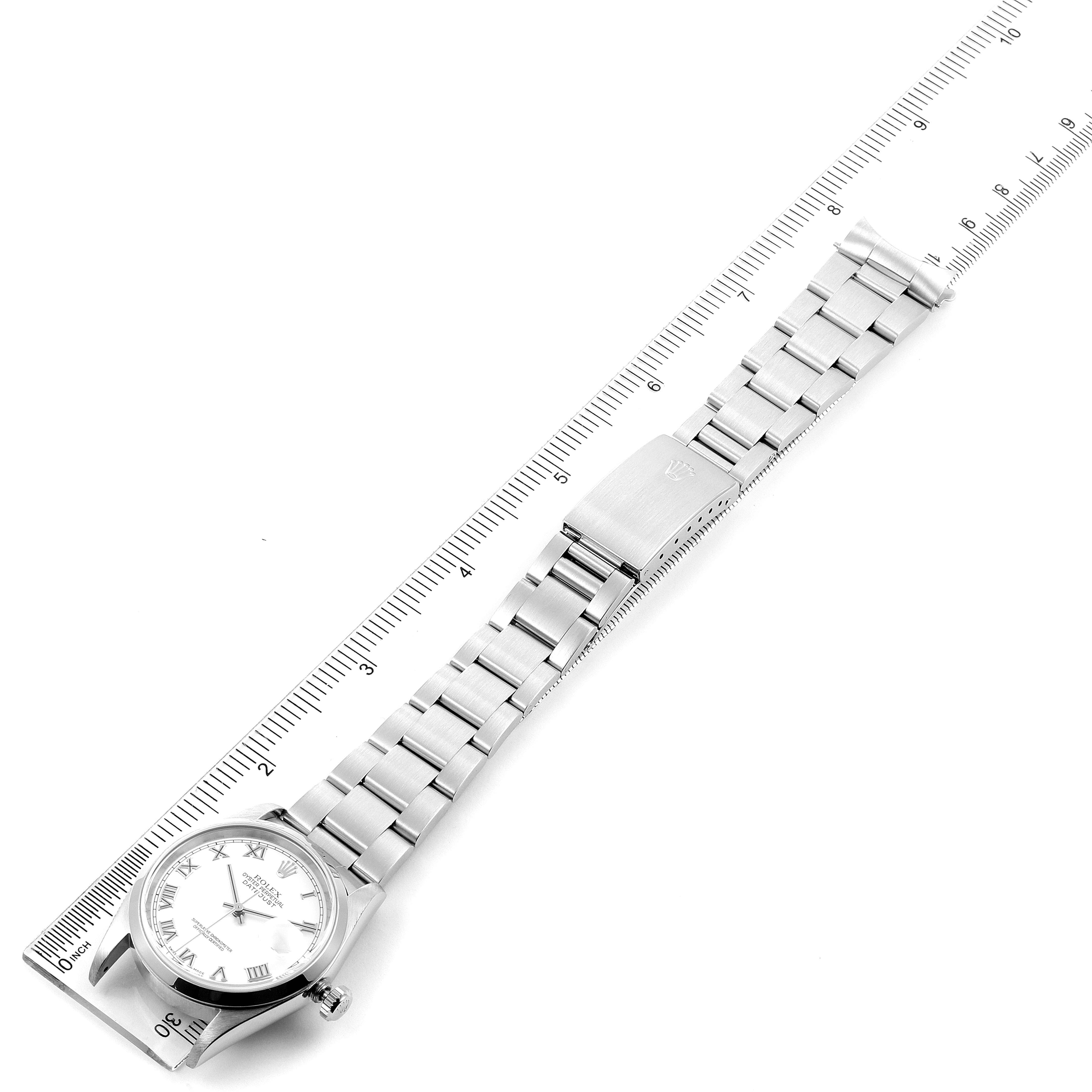 The image shows a Rolex Datejust 16200 Men's Stainless Steel White Dial 16200 Men's Stainless Steel White Dial watch laid flat next to a ruler, displaying the face, bezel, and bracelet.