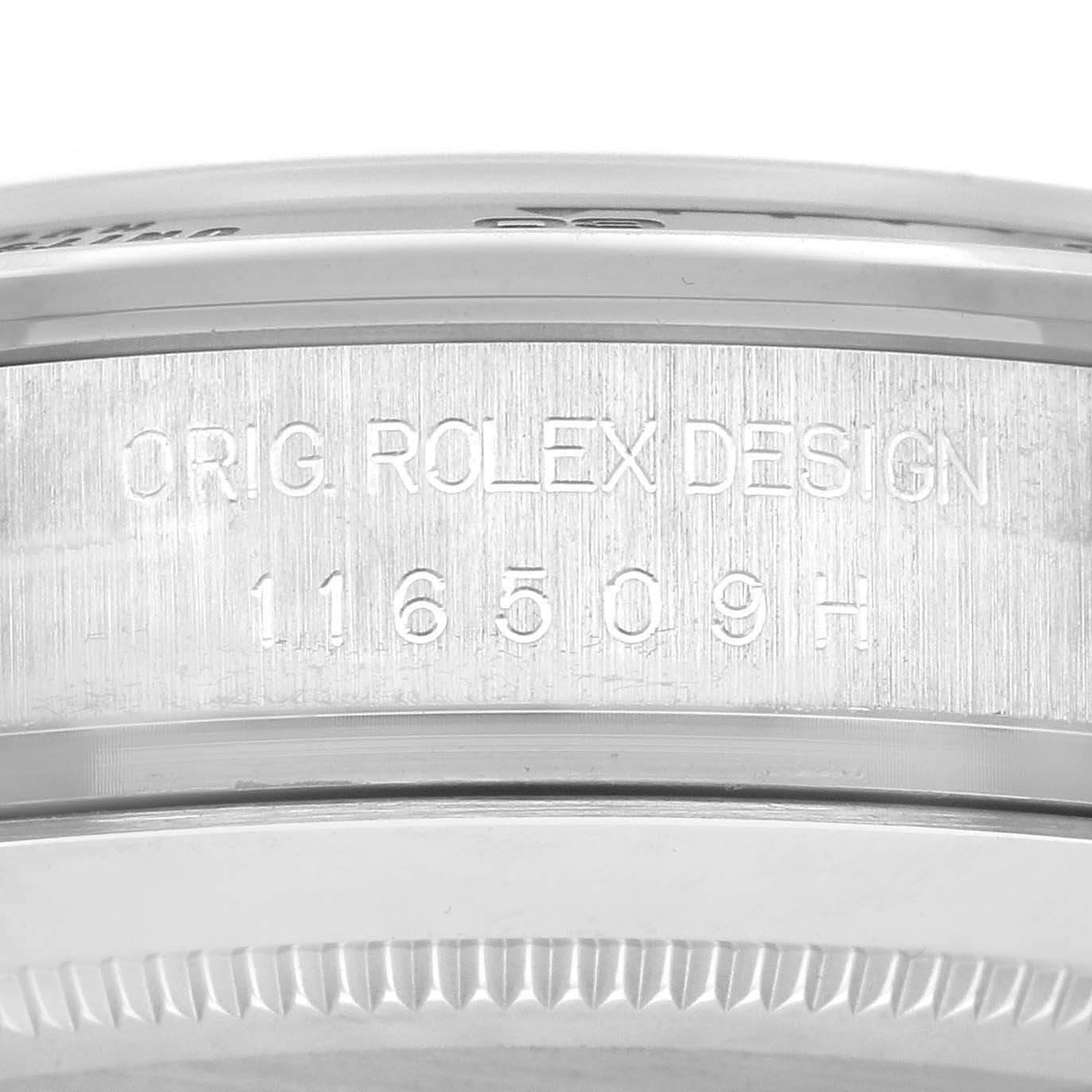 The image shows a close-up of the side of a Rolex Daytona 116509 Men's White Gold Blue Dial 116509 Men's White Gold Blue Dial watch, focusing on the engraved "ORIG ROLEX DESIGN" with a reference number.