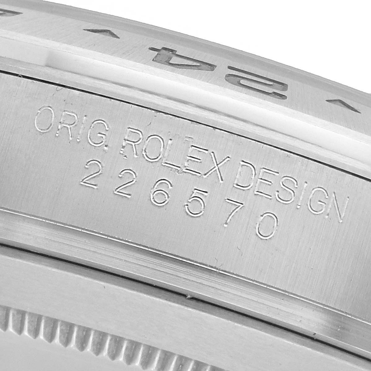 The image shows a close-up of a Rolex Explorer 226570 Men's Stainless Steel White Dial model with focus on the engraved side of the case featuring the text "ORIG. ROLEX DESIGN 226570".
