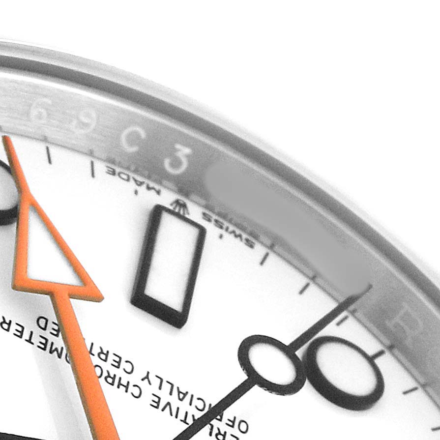 The image shows a close-up of the dial and hands of a Rolex Explorer 226570 Men's Stainless Steel White Dial watch, focusing on the orange hand and some hour markers.