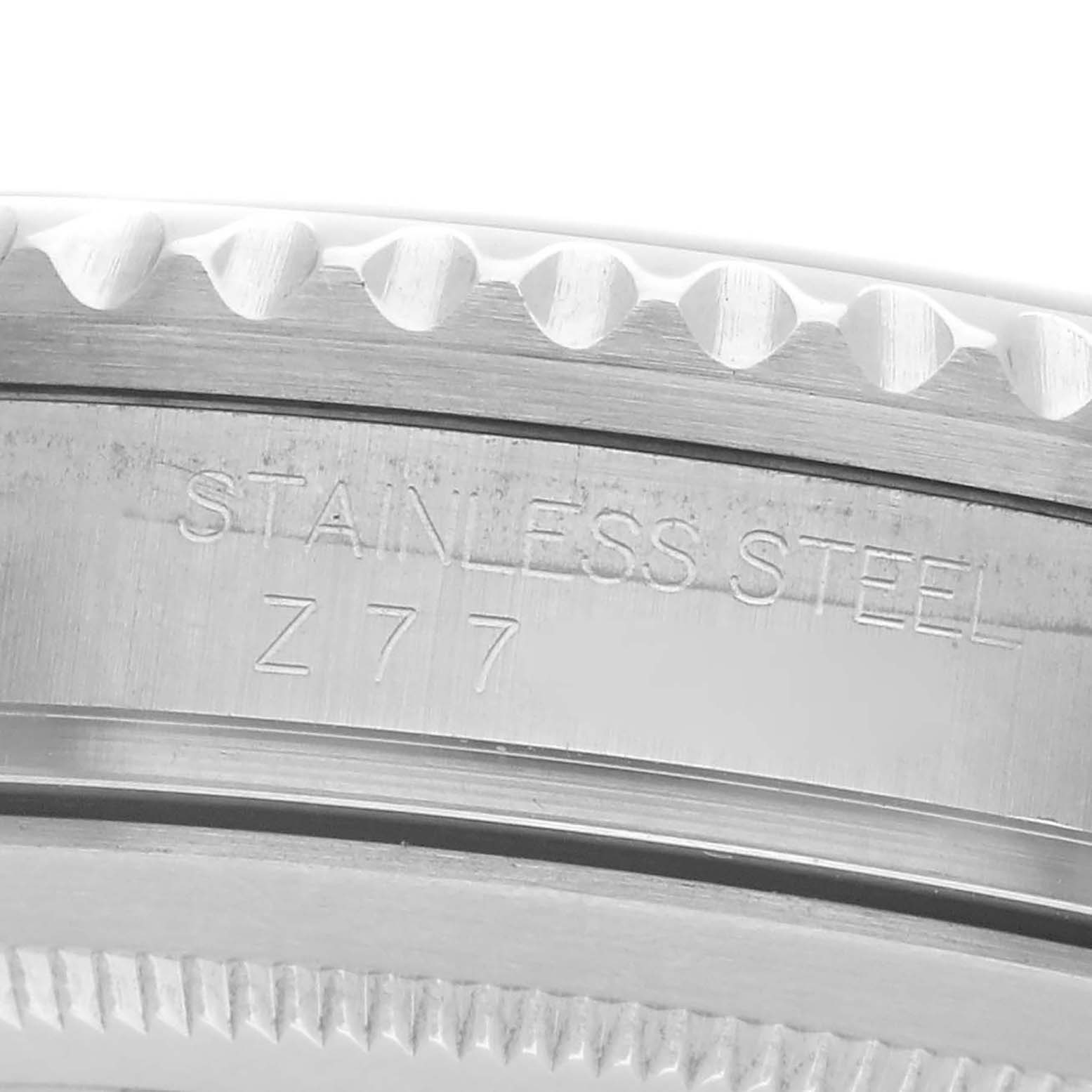 The image shows a close-up side view of the stainless steel bezel and engraving of the Rolex GMT-Master 16710 Men's Stainless Steel Black Dial.