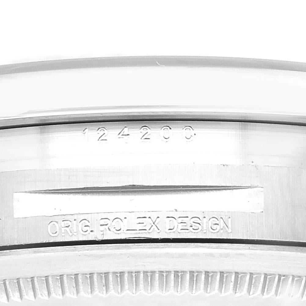 This image shows the reference number and "ORIG. ROLEX DESIGN" engraving on the case side of a Rolex Oyster Perpetual 124200 Men
s Stainless Steel Blue Dial 124200 Men
s Stainless Steel Blue Dial watch.