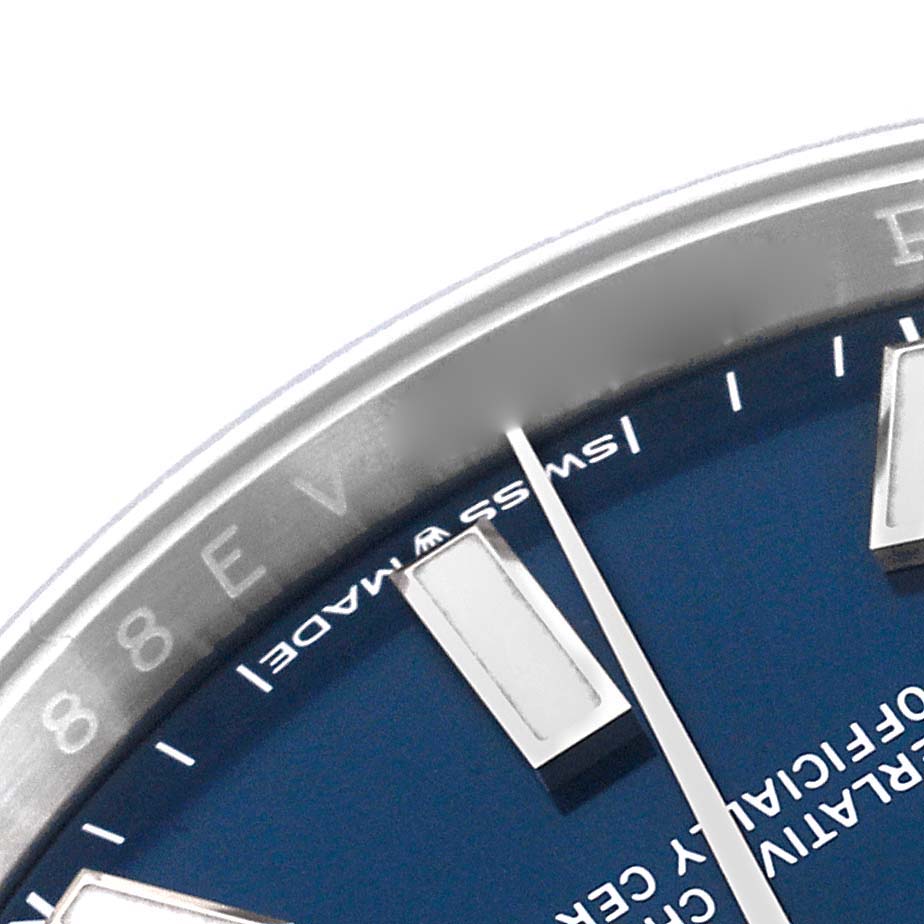 A close-up of the Rolex Oyster Perpetual 124200 Men
s Stainless Steel Blue Dial 124200 Men
s Stainless Steel Blue Dial watch showing part of the blue dial, indices, and bezel edge.