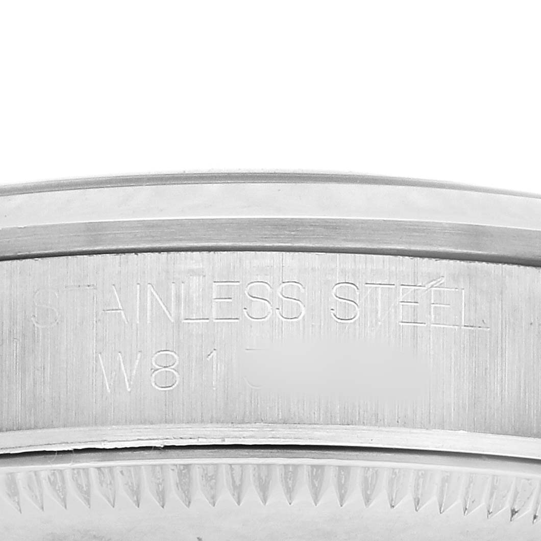 The image shows a close-up of the case side of a Rolex Mid-Size 67480 Women's Stainless Steel Blue Dial watch, highlighting the "Stainless Steel" engraving.