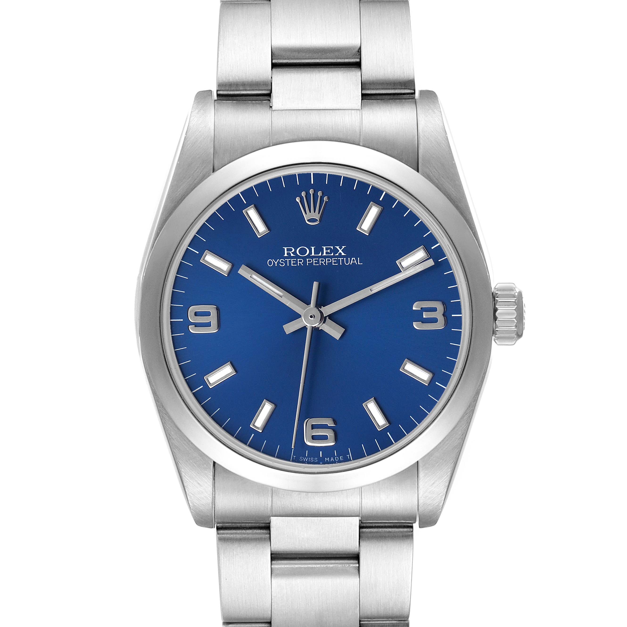 The image shows a front view of a Rolex Oyster Perpetual Mid-Size watch, highlighting its blue dial, silver markers, and stainless steel bracelet.